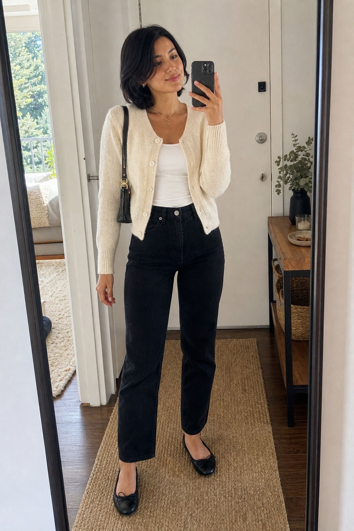 Woman wearing black jeans with a soft cardigan, a grocery store outfit