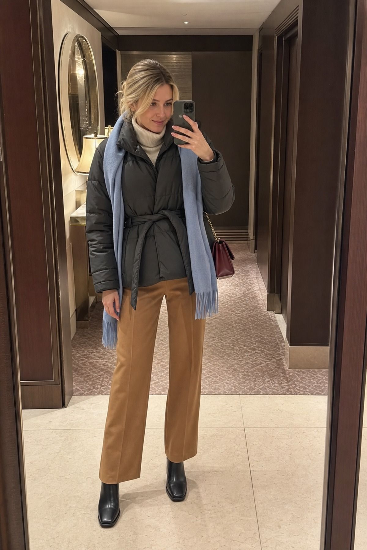 Woman wearing a belted puffer with straight pants, a puffer jacket outfit