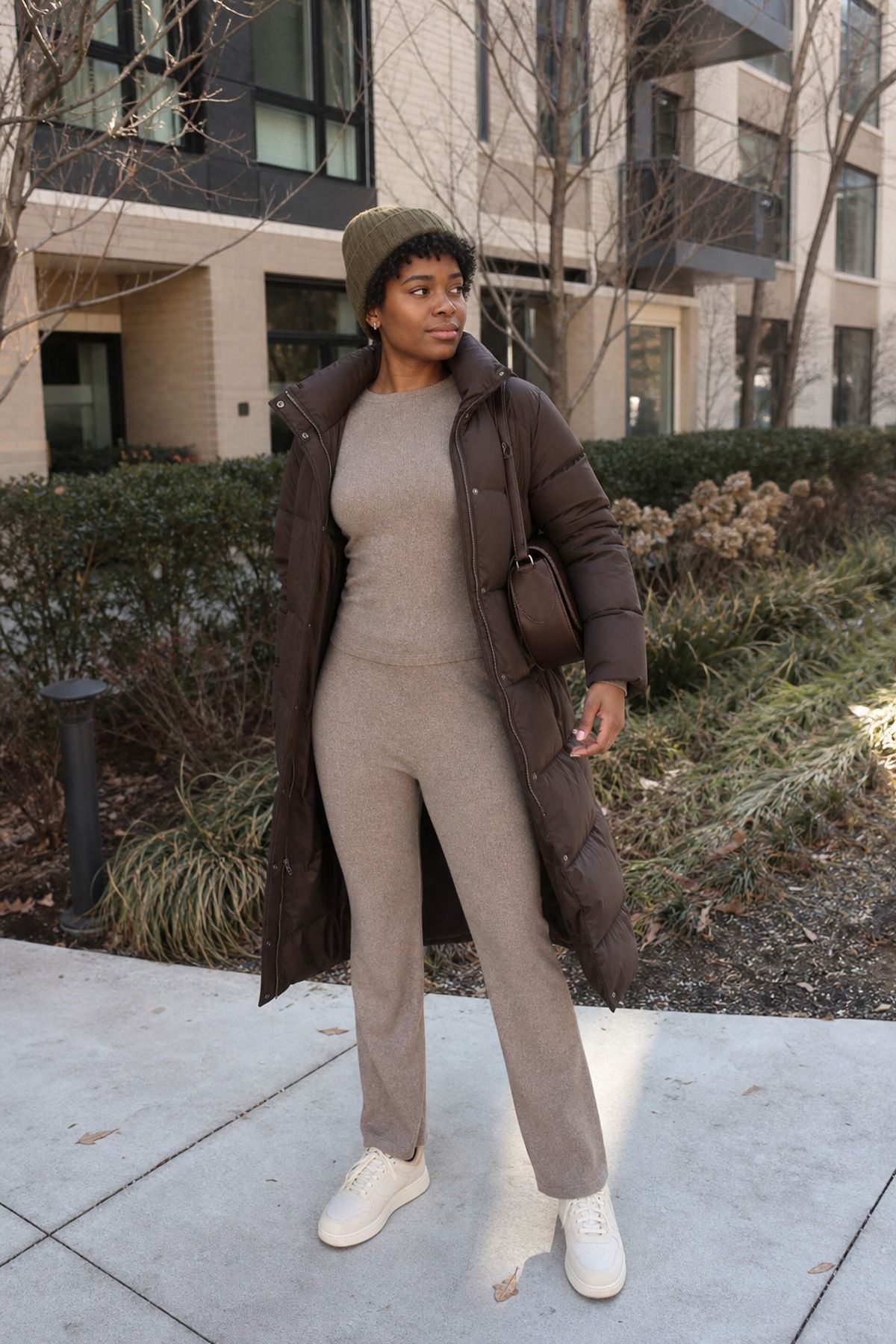 Woman wearing a puffer with a matching knit set, a puffer jacket outfit