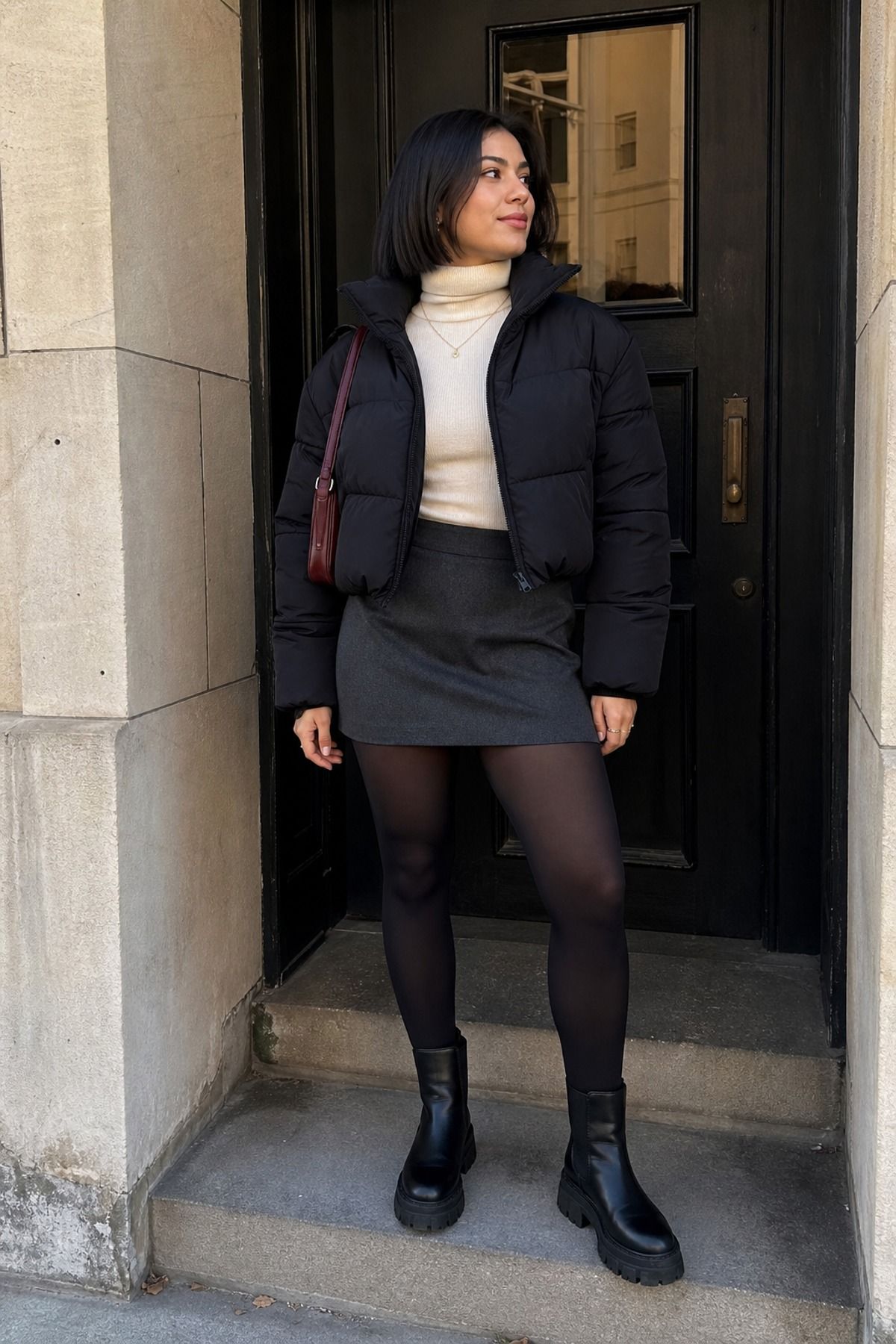 Woman wearing a puffer with a turtleneck and mini skirt, a puffer jacket outfit