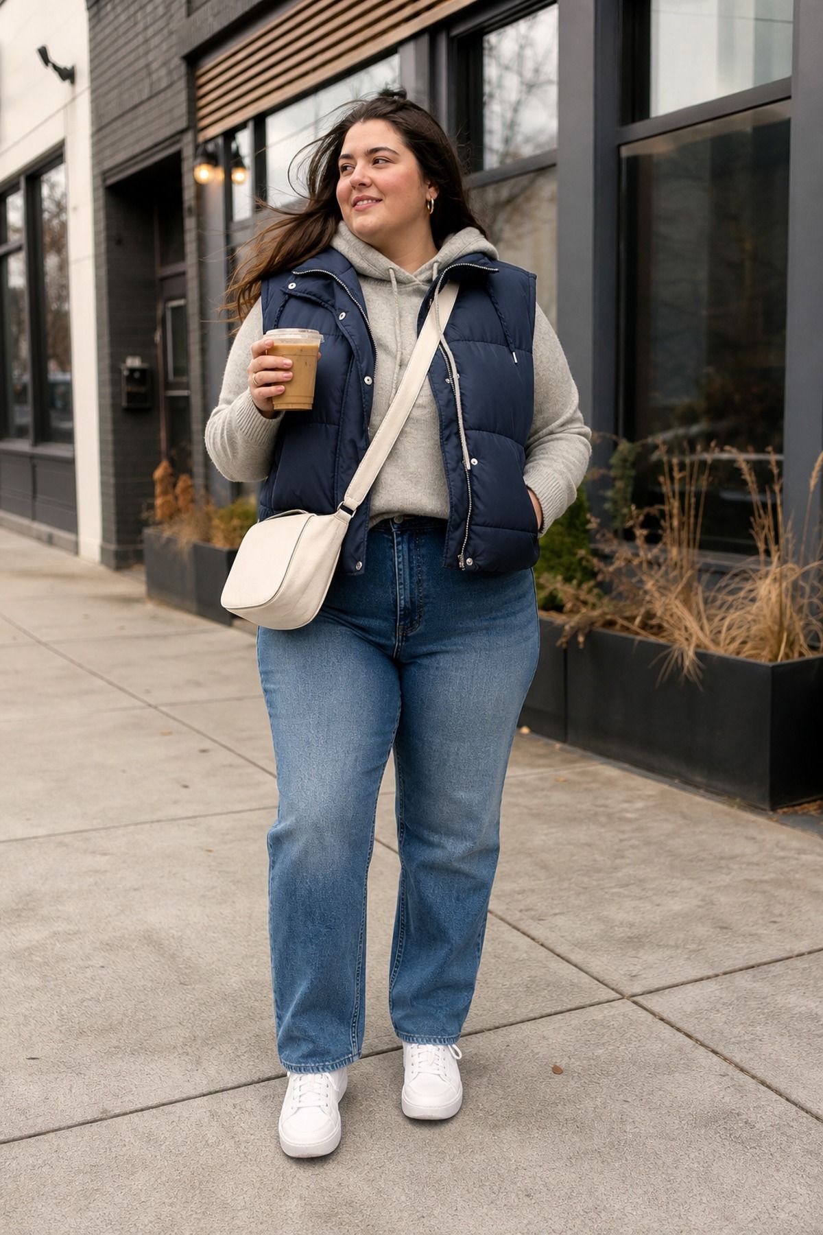 Woman wearing a puffer vest with a knit hoodie, a windy day outfit