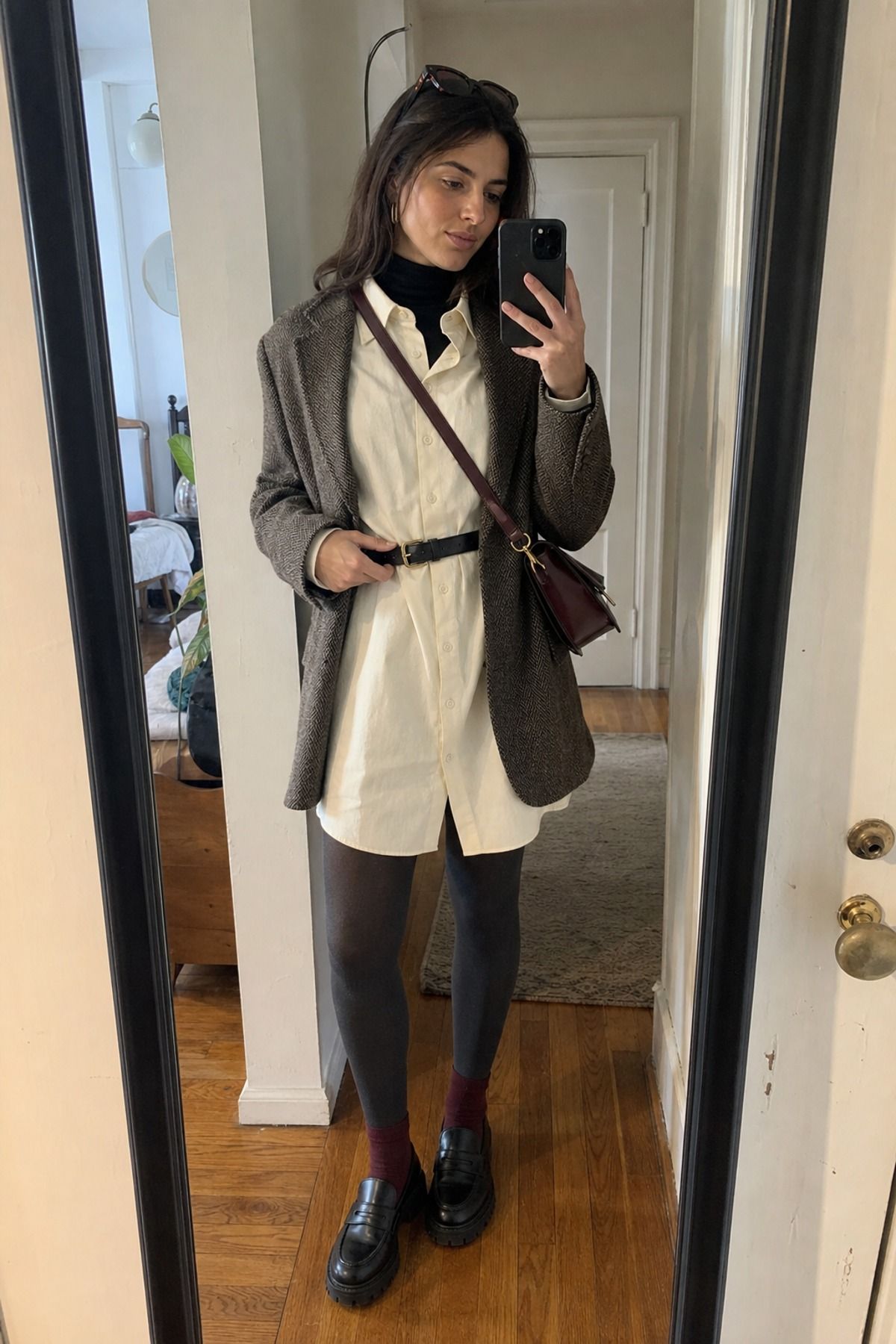 Woman wearing a shirt dress with tights and loafers, a winter dress outfit