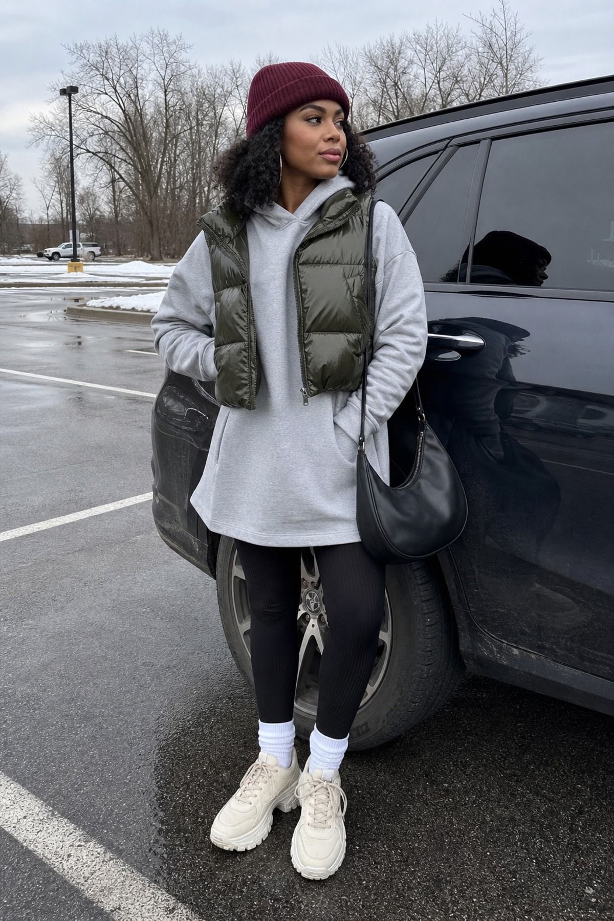 Woman wearing a hoodie dress with a puffer vest, a winter dress outfit