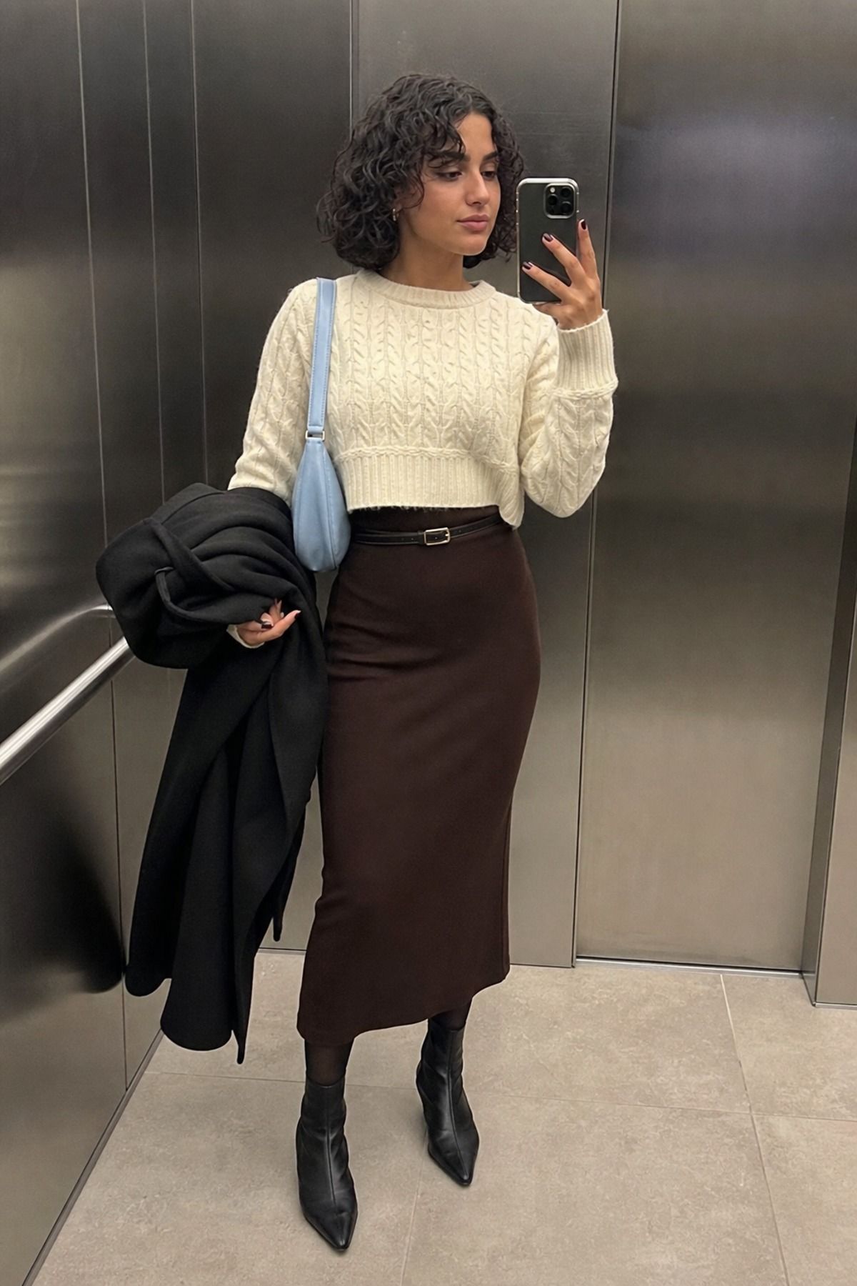 Woman wearing a column dress with a cropped sweater, a winter dress outfit
