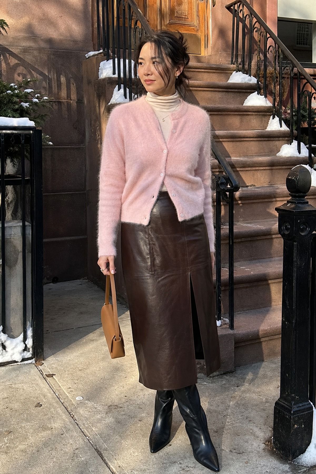Woman wearing a leather skirt with a soft cardigan, a winter skirt outfit