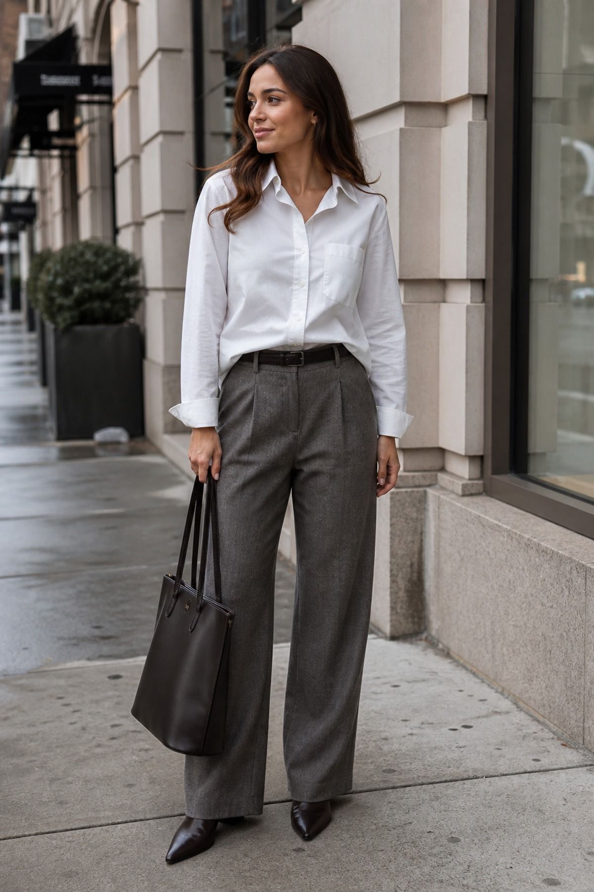 Woman wearing a white button down with wool trousers, a winter to spring outfit