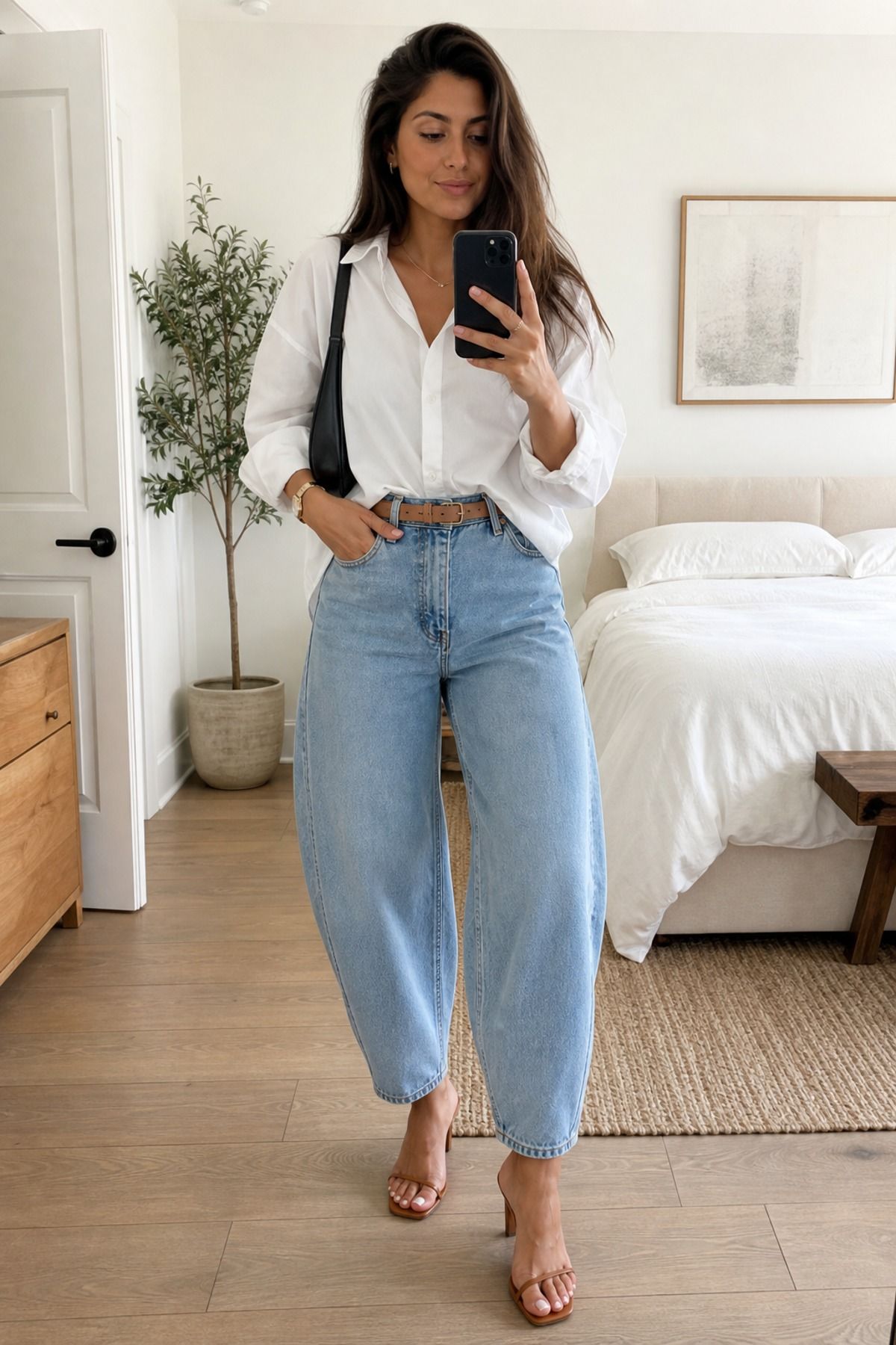 Woman wearing barrel jeans with a white poplin shirt