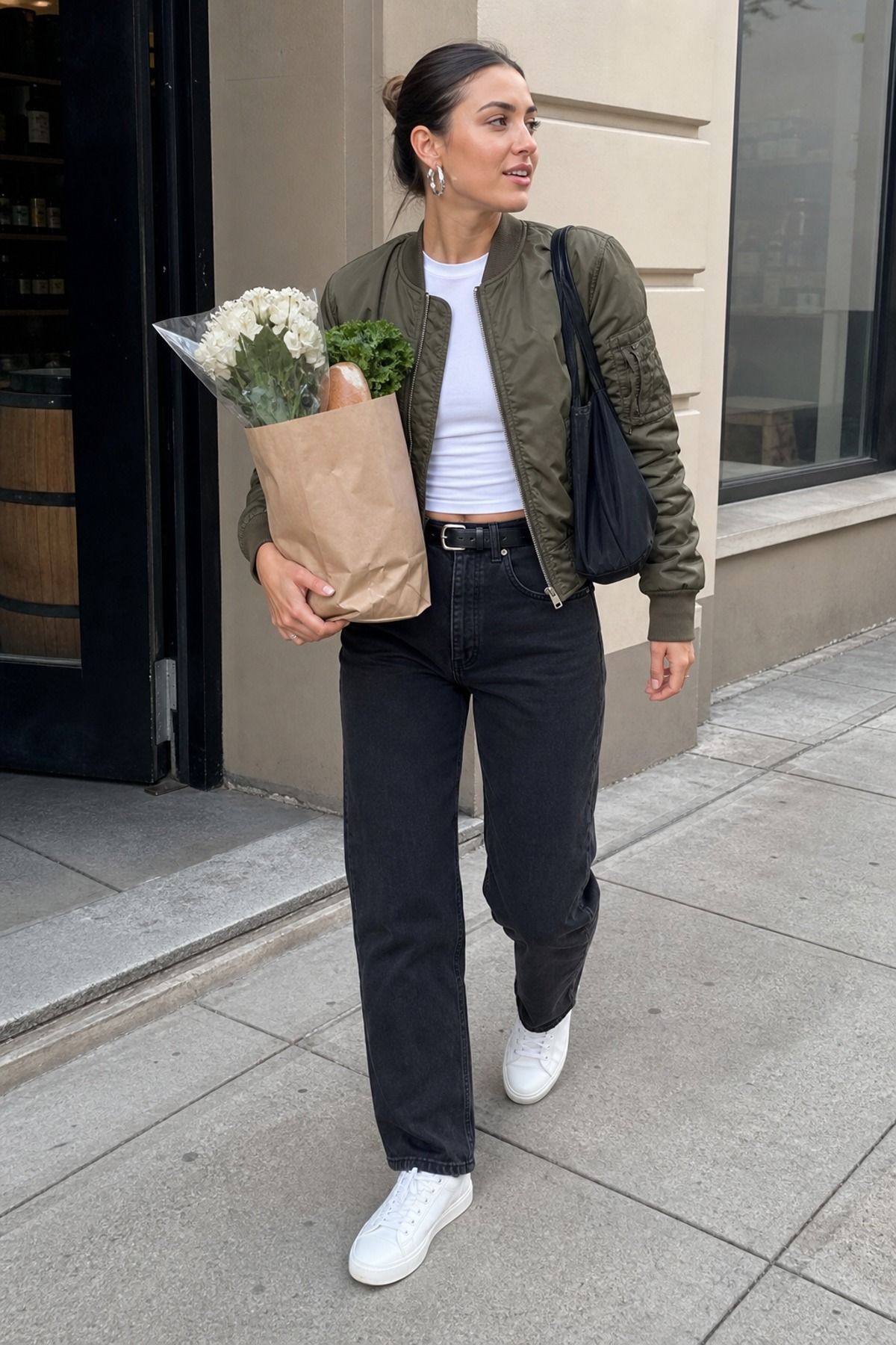 Woman wearing black jeans with a bomber jacket