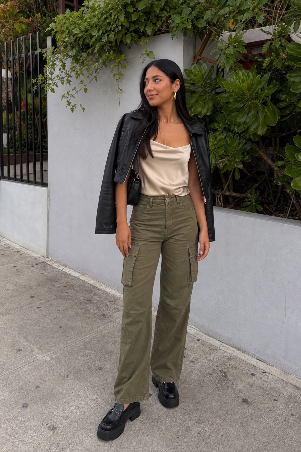 Woman wearing cargo pants with a satin tank, a casual party outfit
