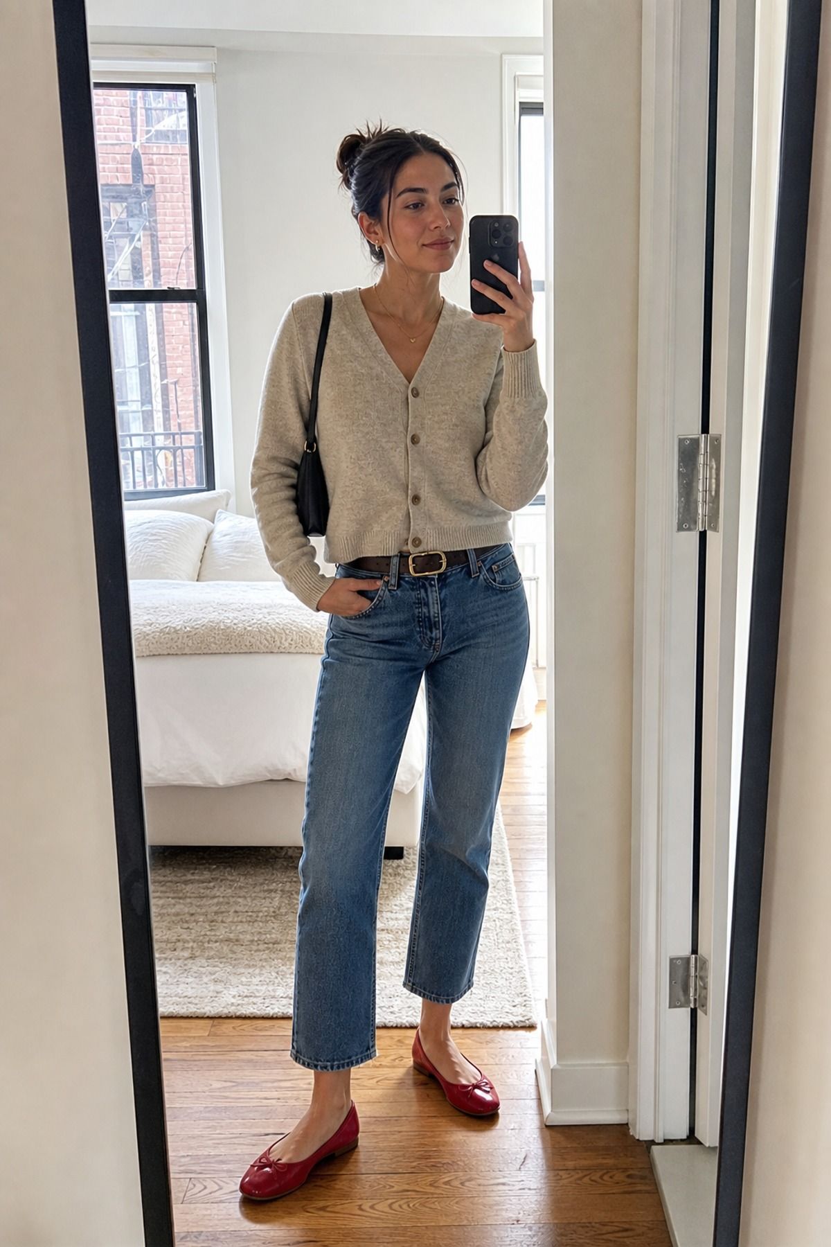 Woman wearing cropped jeans with a short cardigan
