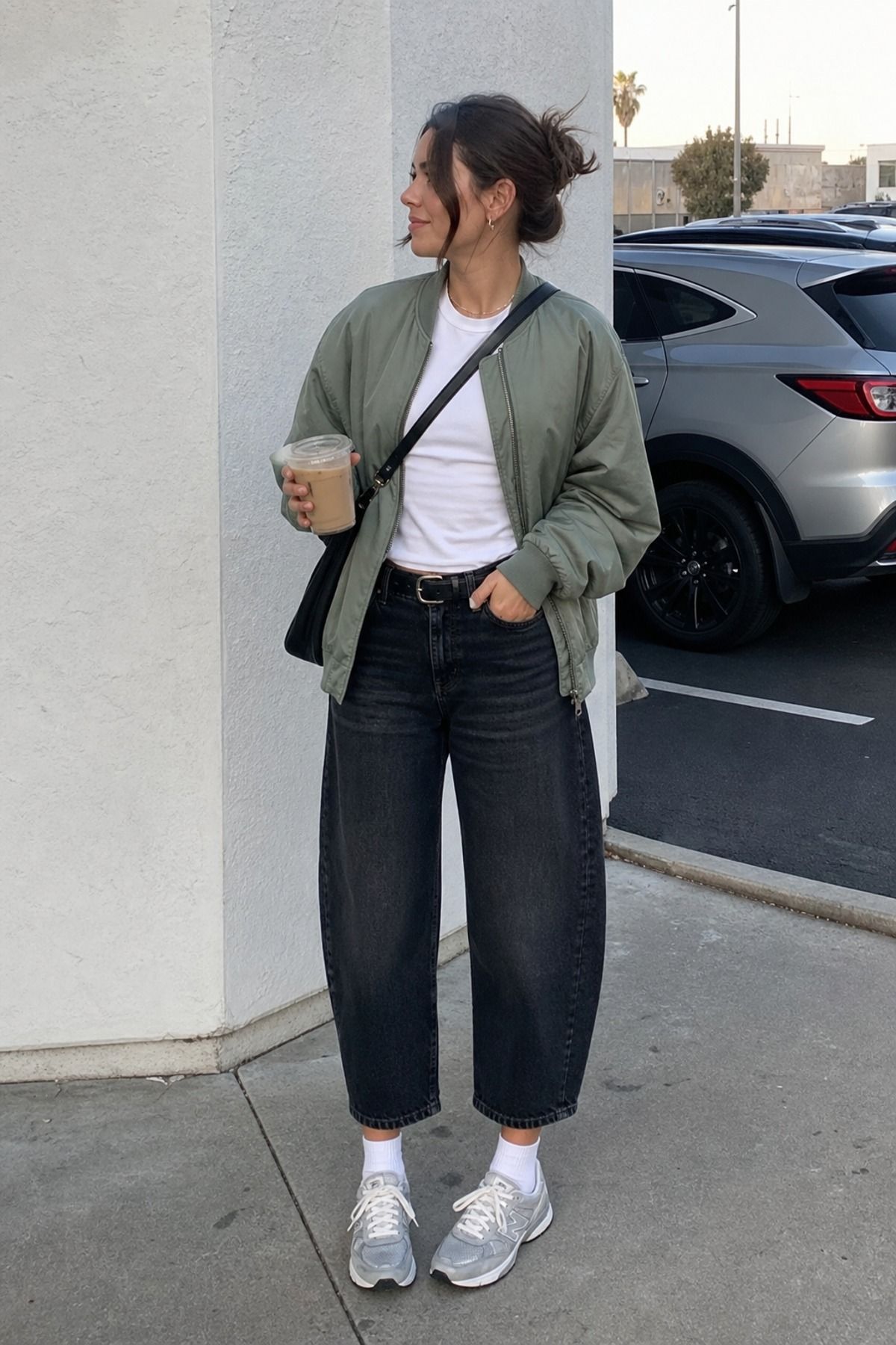 Woman wearing cropped jeans with a soft bomber