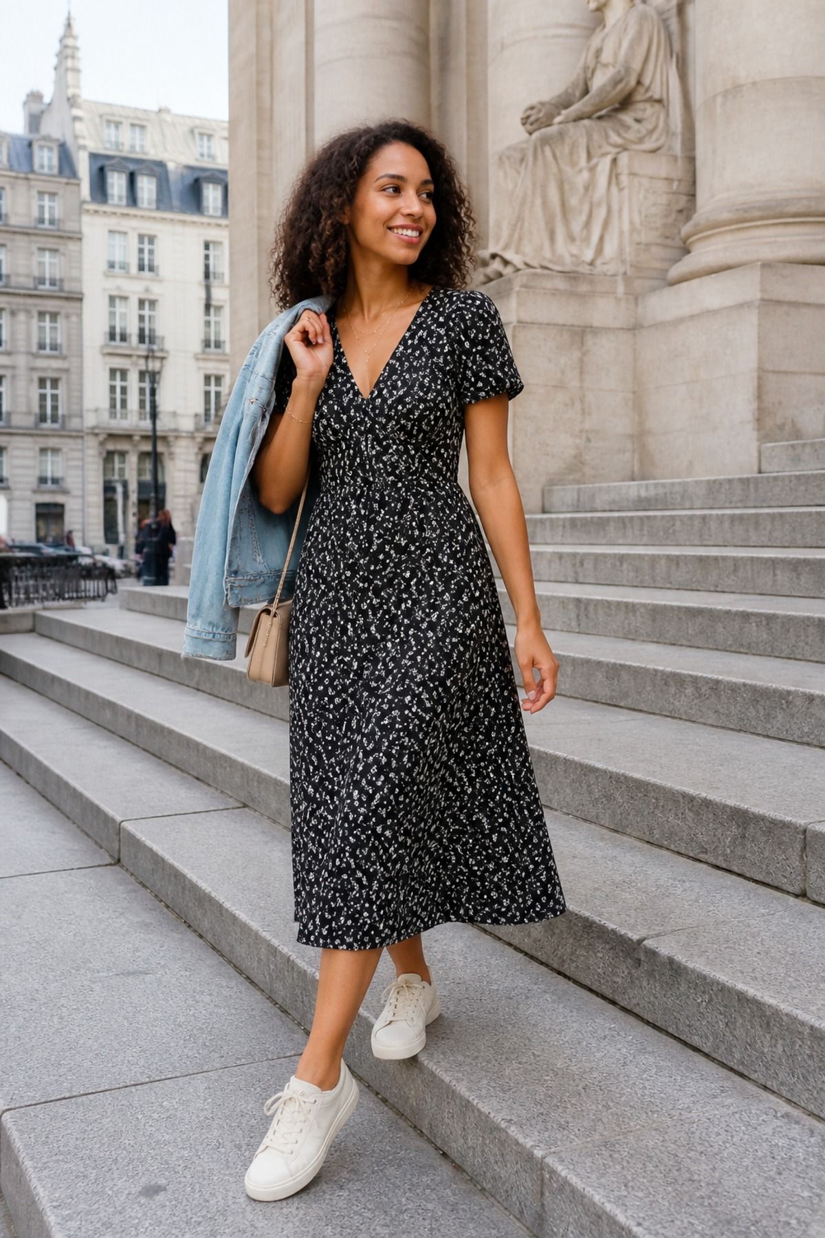 Woman wearing a midi dress with sneakers, an Europe travel outfit