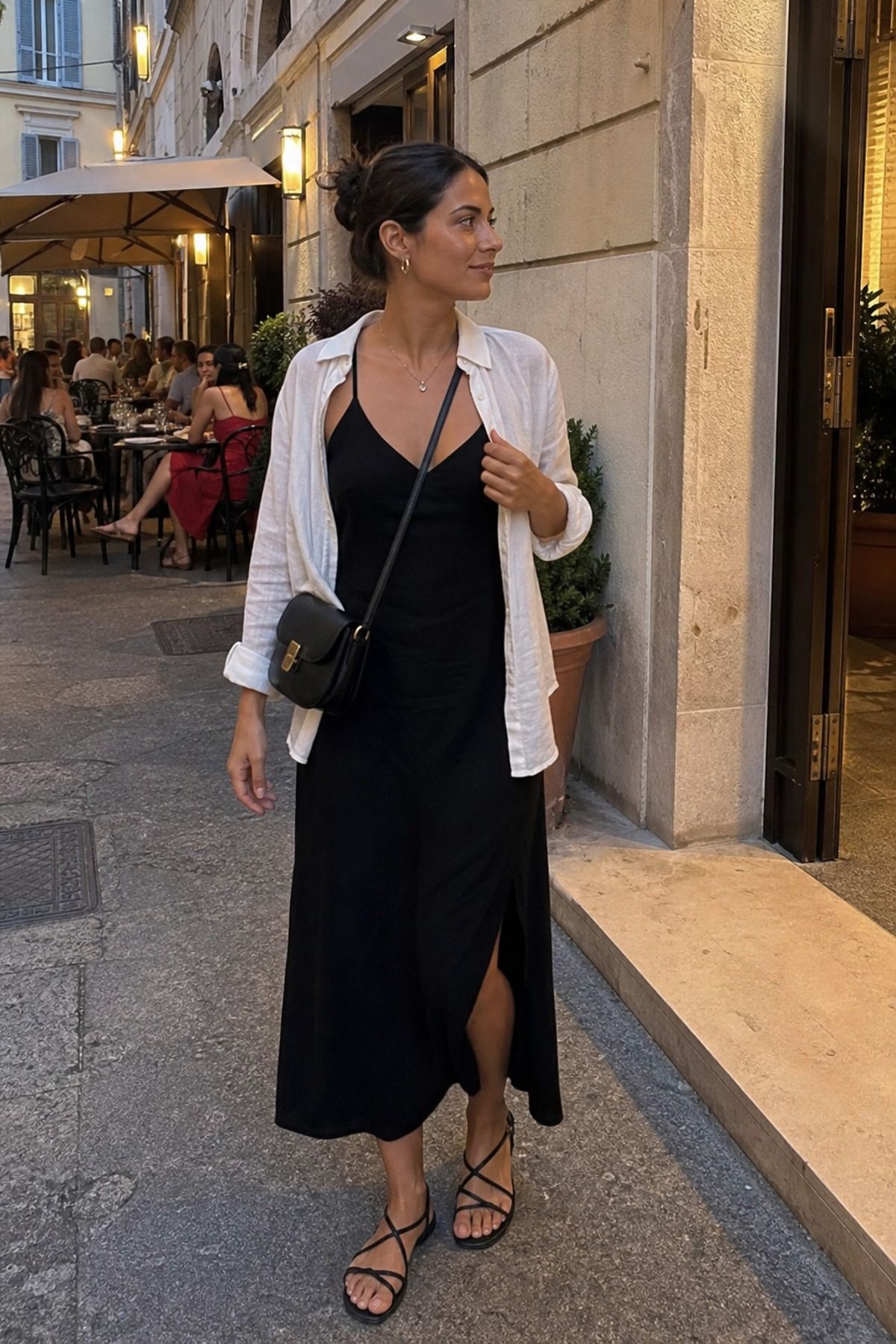 Woman wearing a black dress with flat sandals, an Europe travel outfit