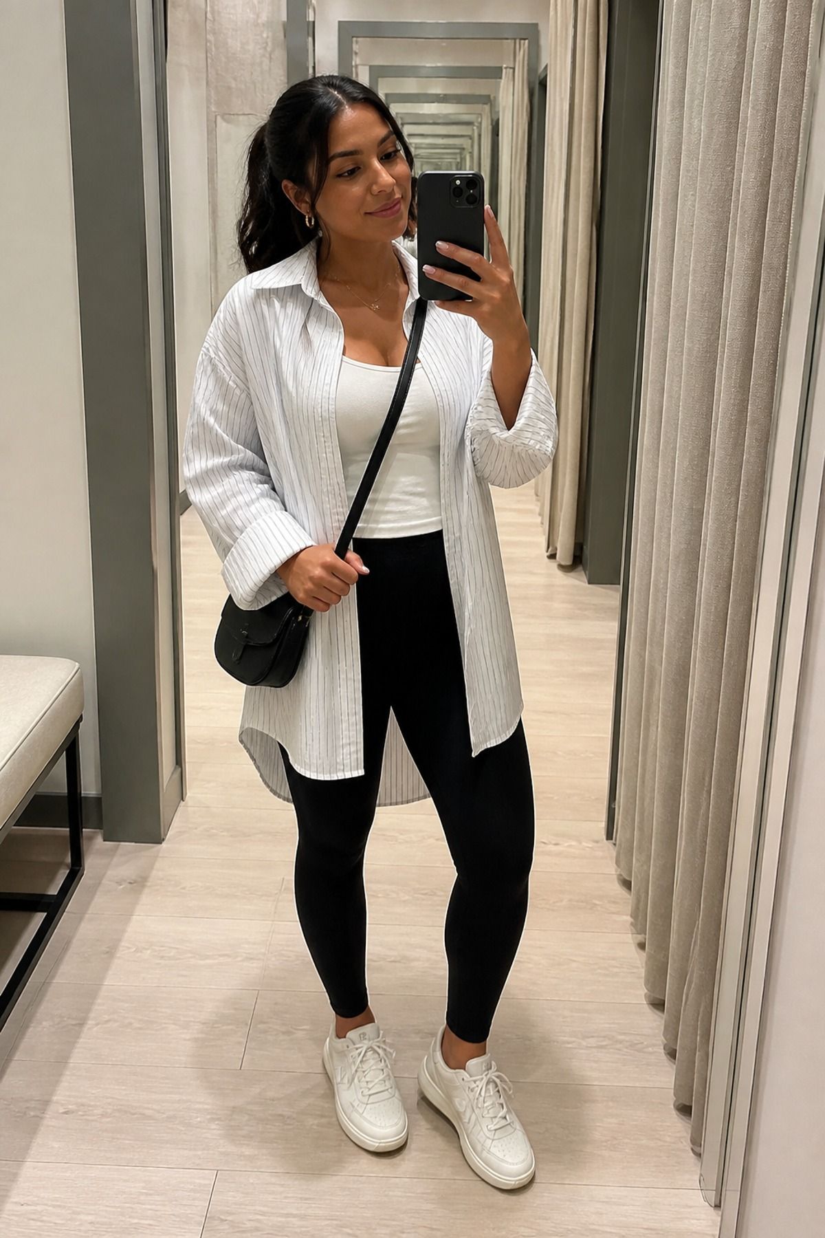 Woman wearing leggings with a long button down, a shopping day outfit