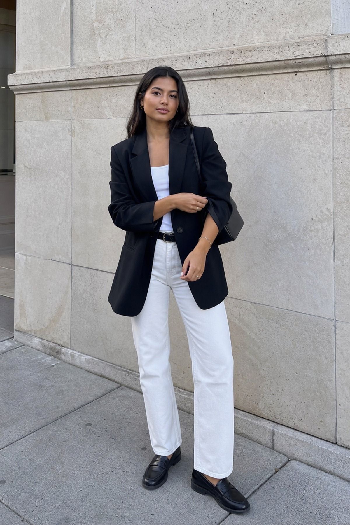 Woman wearing white jeans with a black blazer