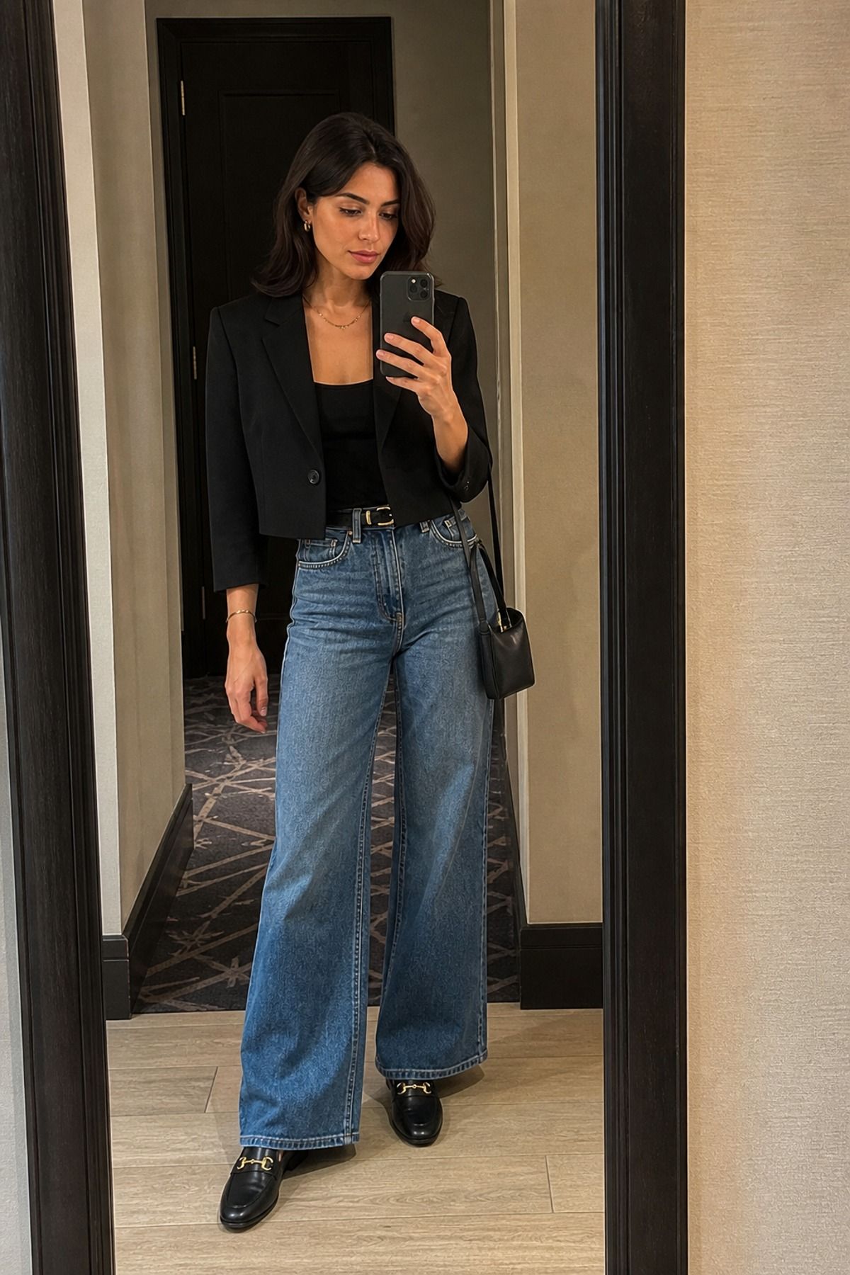 Woman wearing wide leg jeans with a cropped blazer