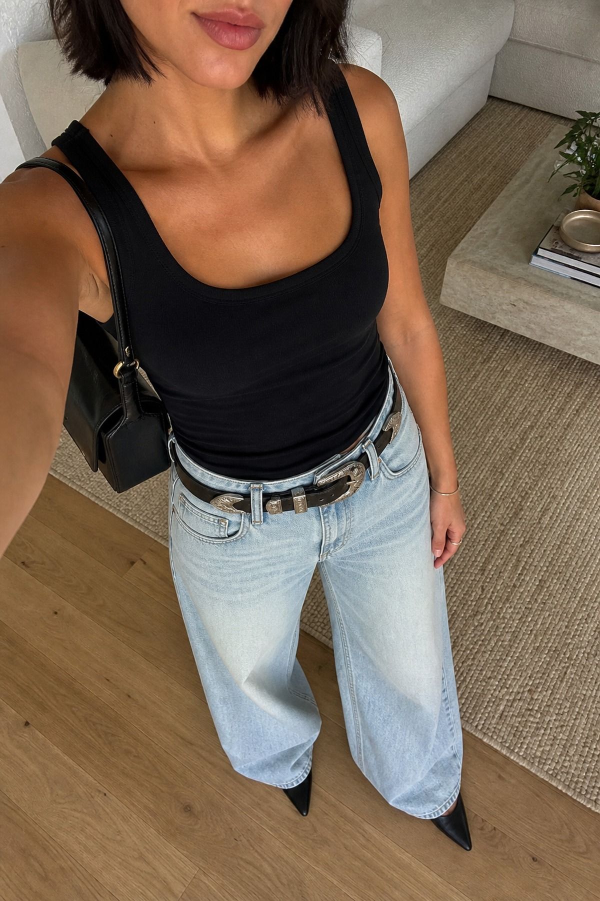 Woman wearing wide leg jeans with a statement belt