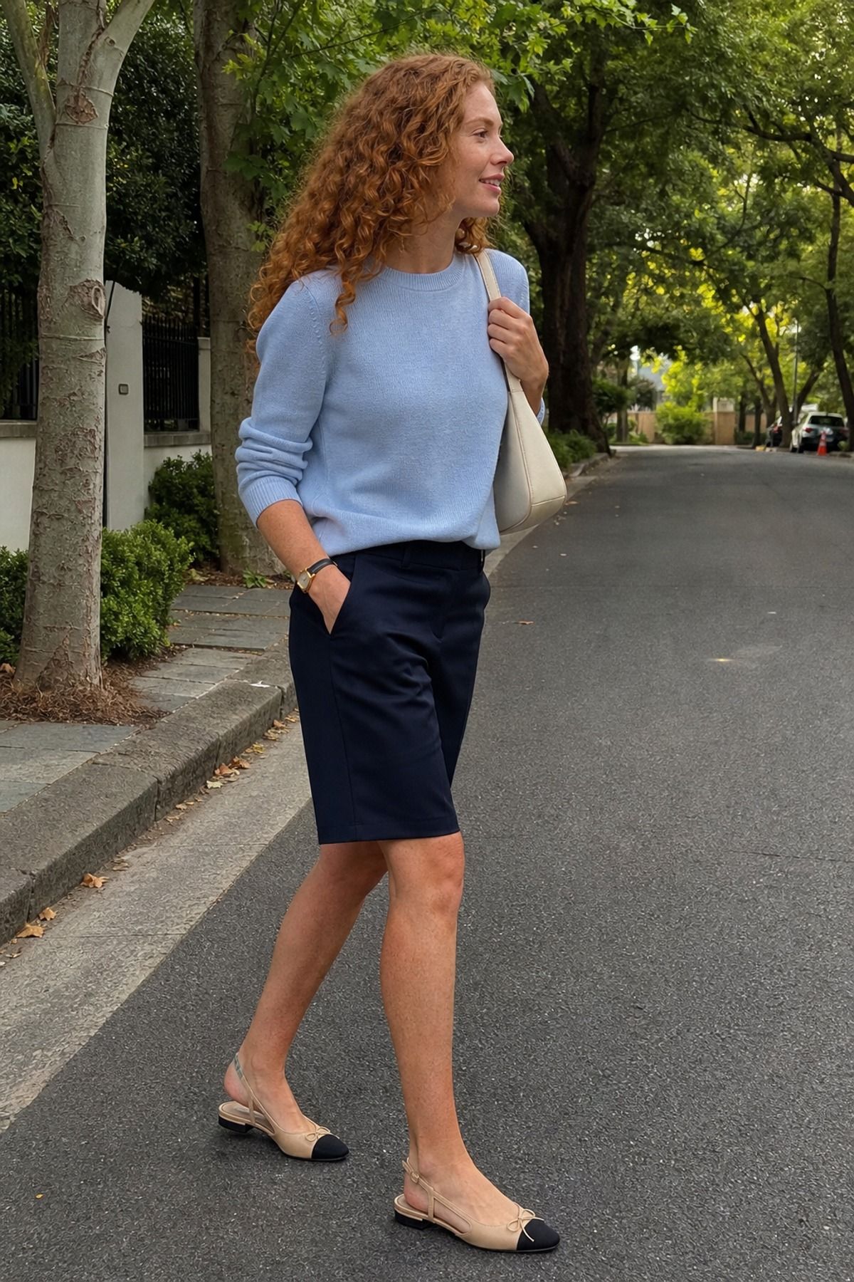 Woman wearing bermuda shorts with a sweater