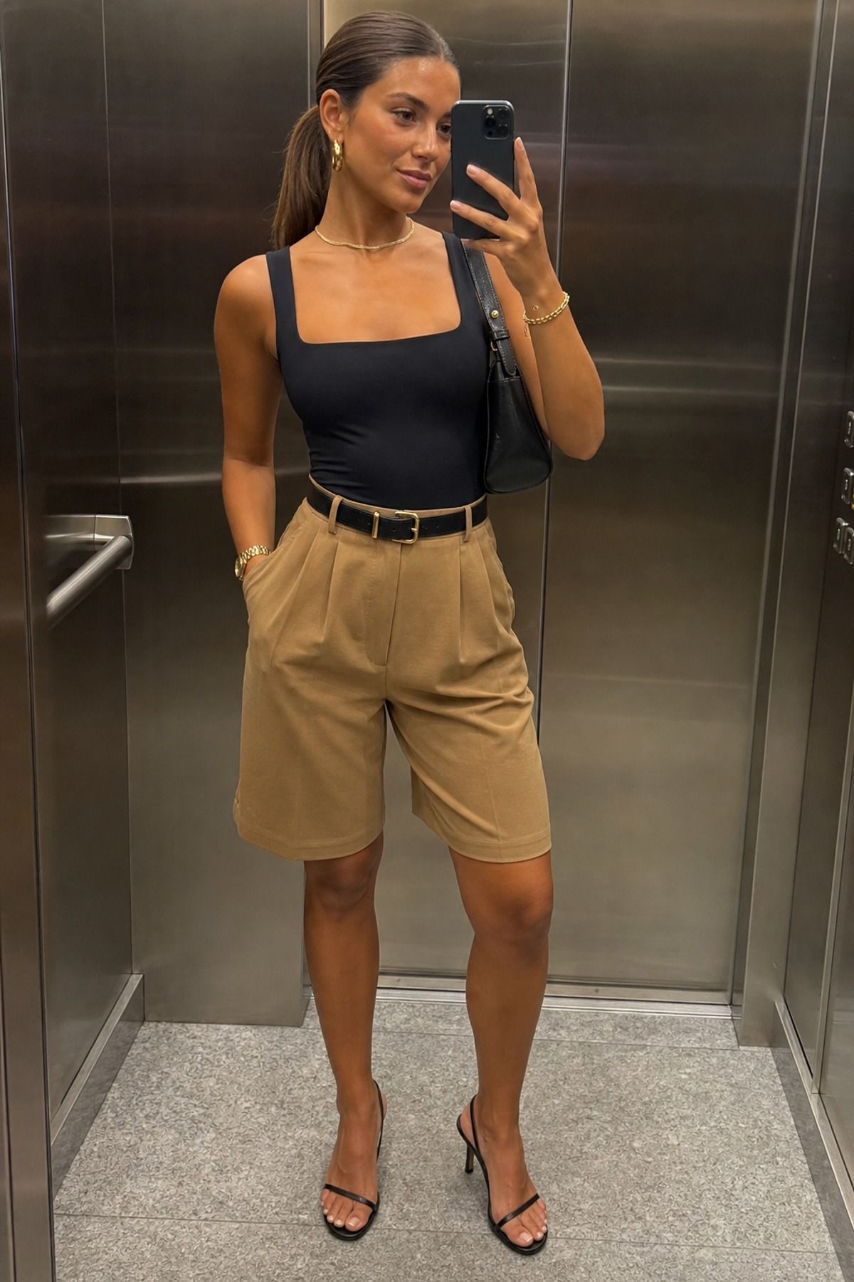 Woman wearing bermuda shorts with a bodysuit
