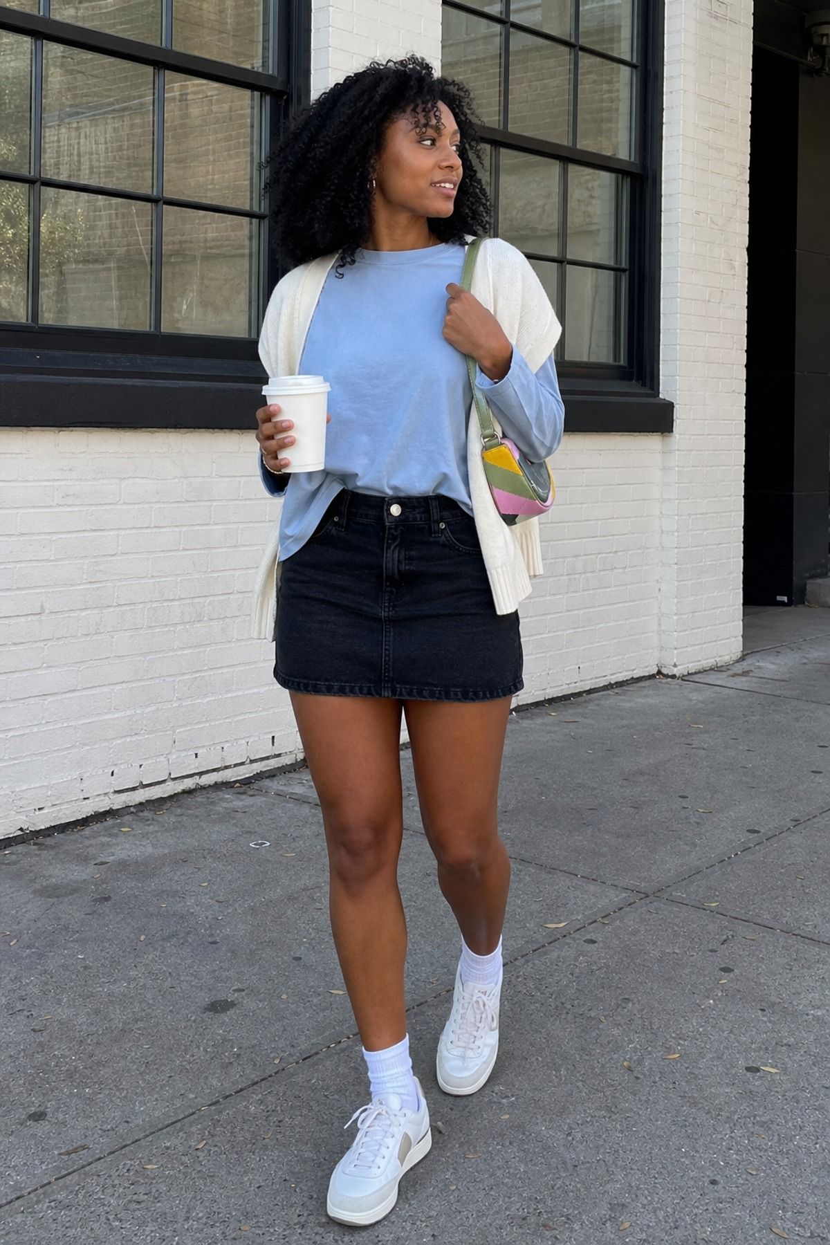 Woman wearing a black skirt with sneakers