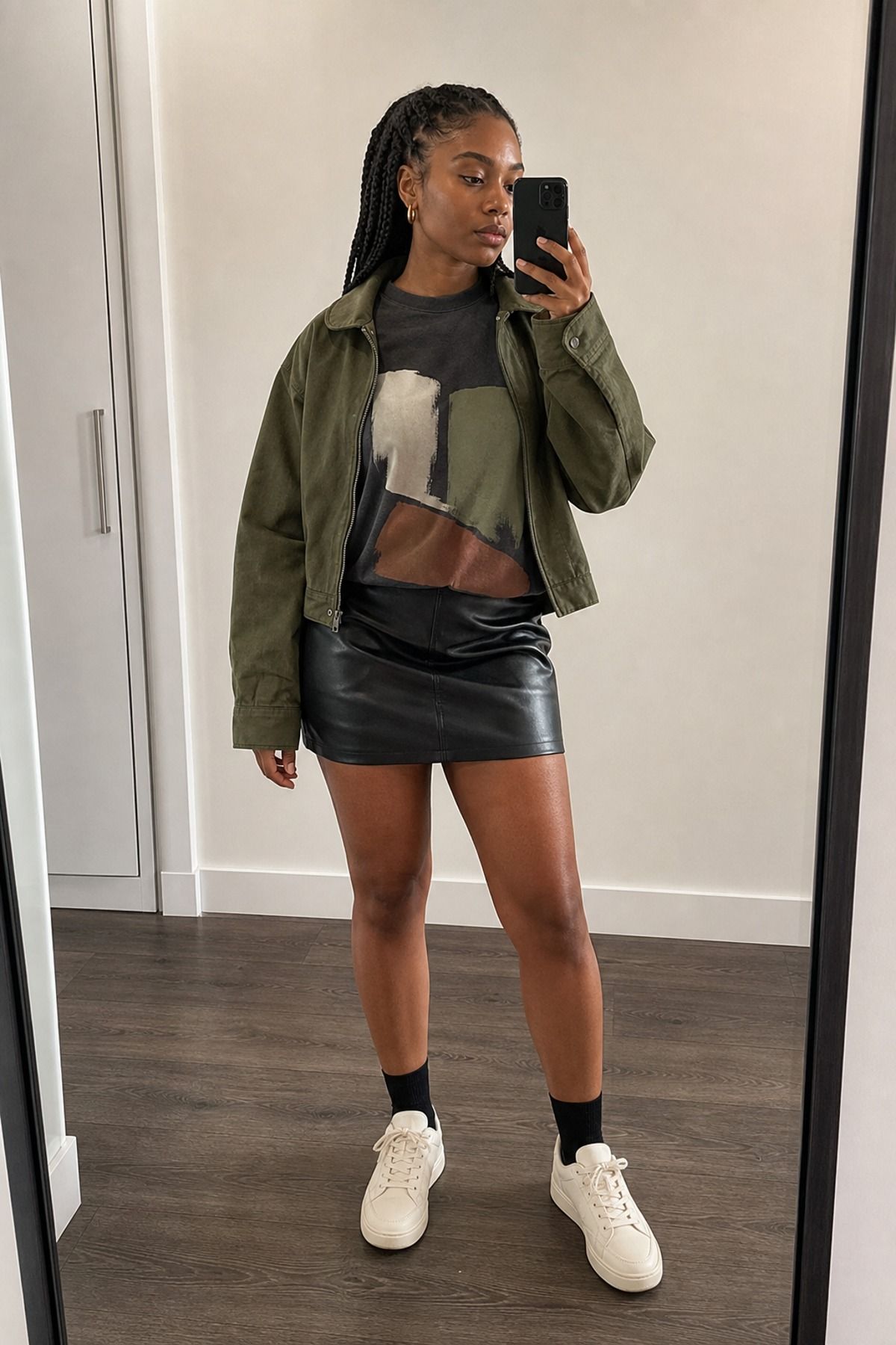 Woman wearing a black skirt with a graphic tee