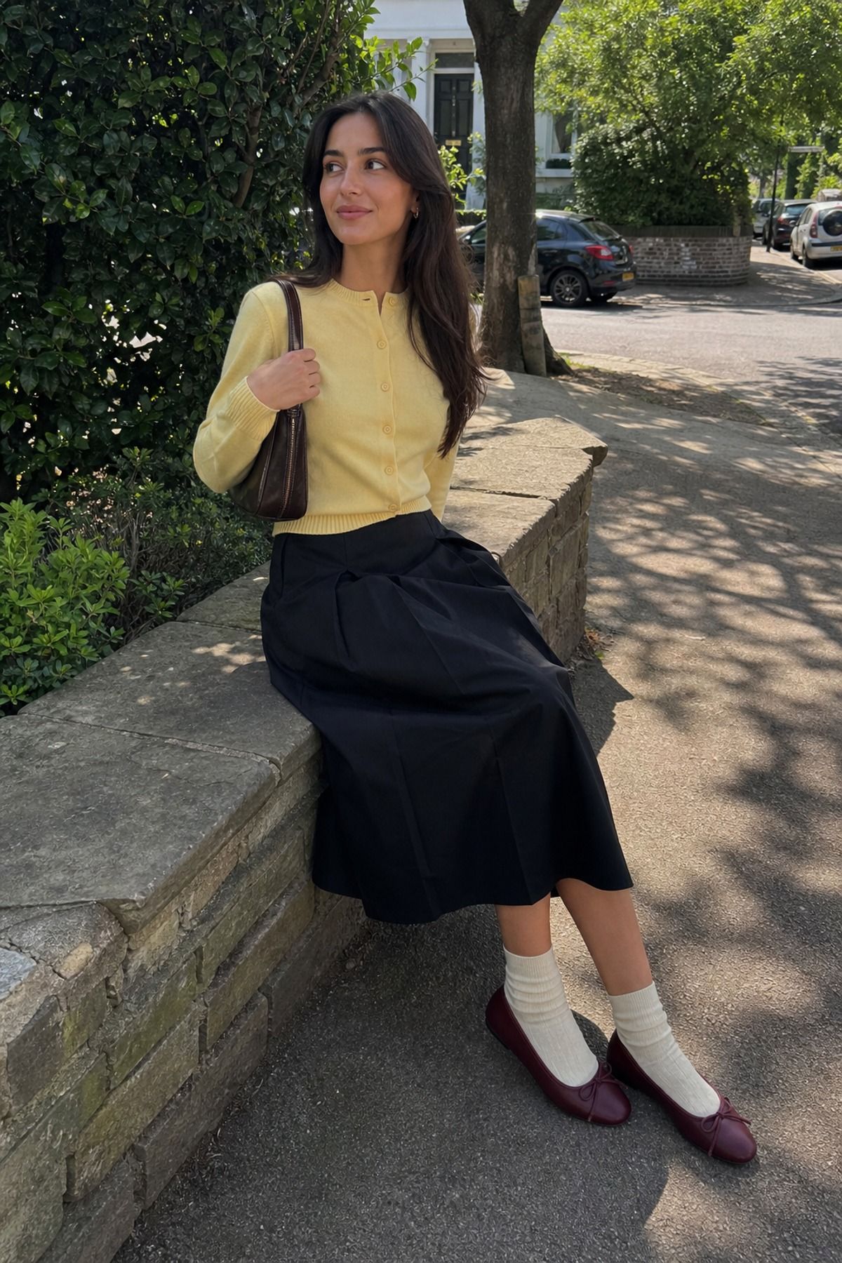 Woman wearing a black skirt with ballet flats