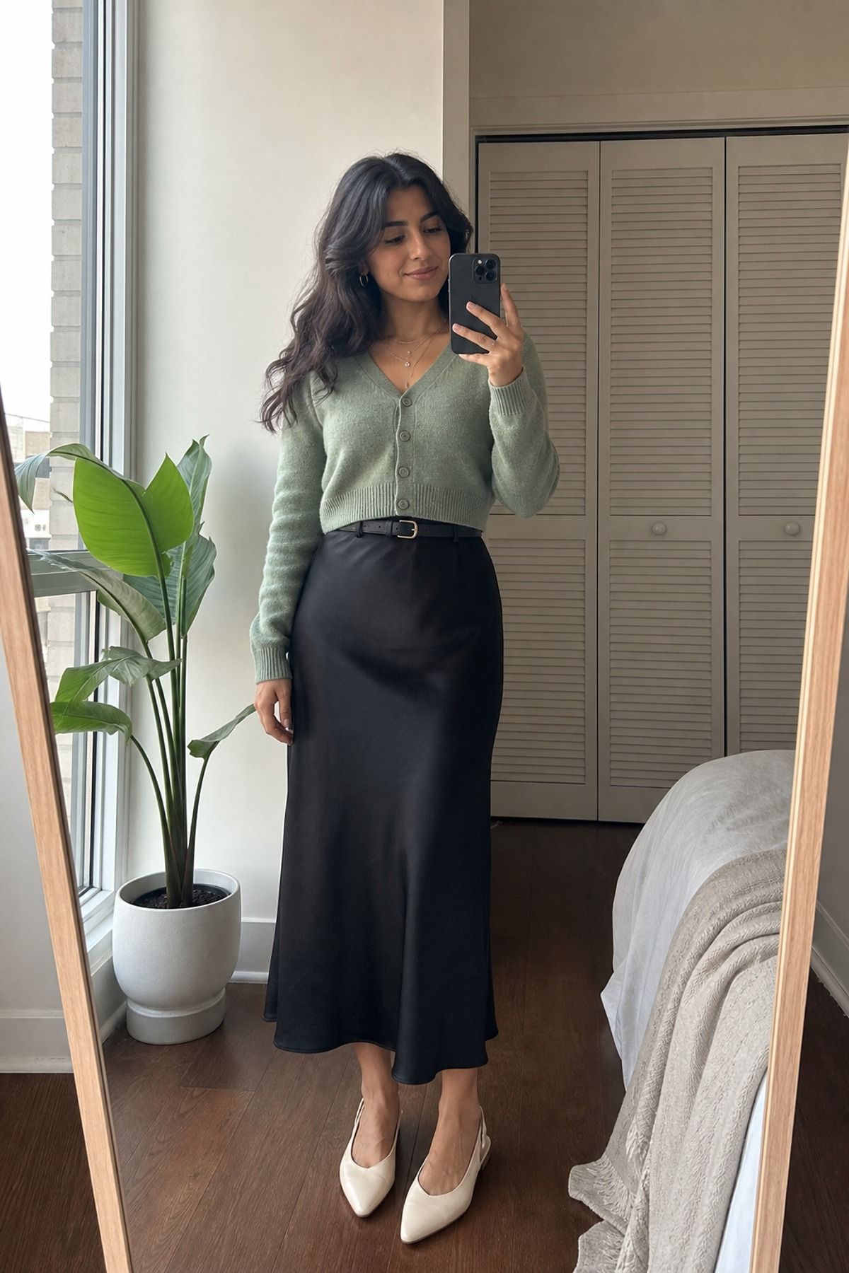 Woman wearing a black skirt with a cardigan