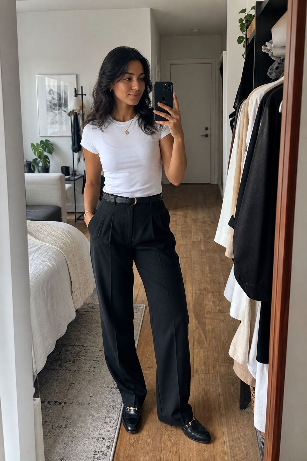 Woman wearing black trousers with a white tee