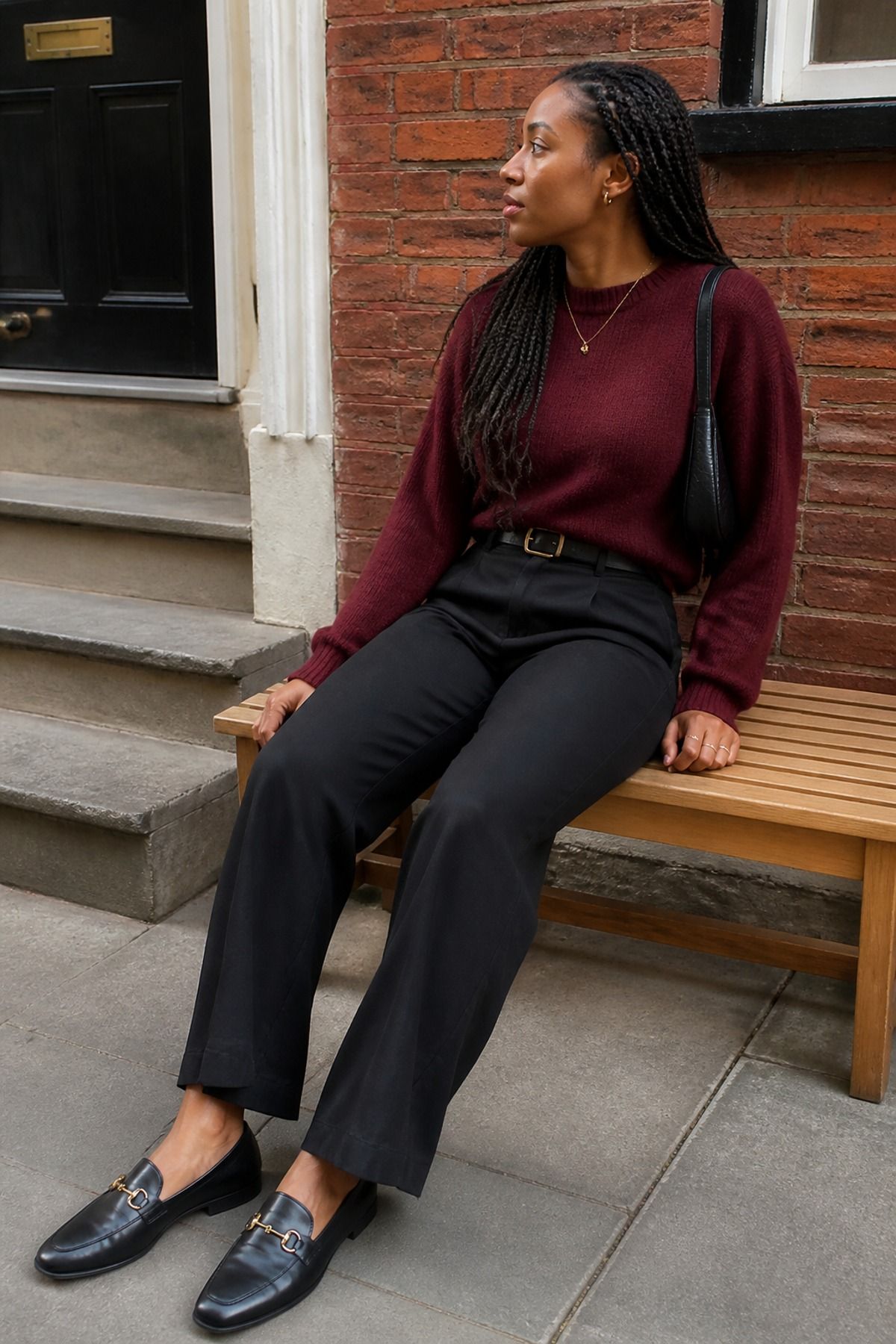 Woman wearing black trousers with a sweater