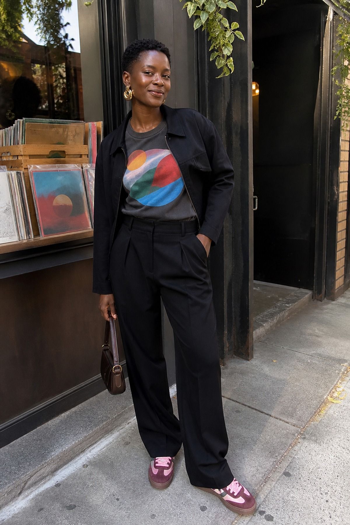 Woman wearing black trousers with a graphic tee