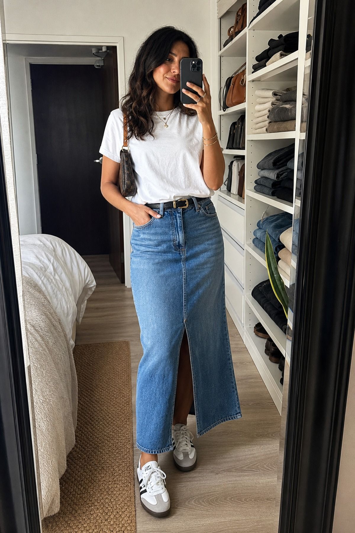 Woman wearing a denim maxi skirt with a white tee
