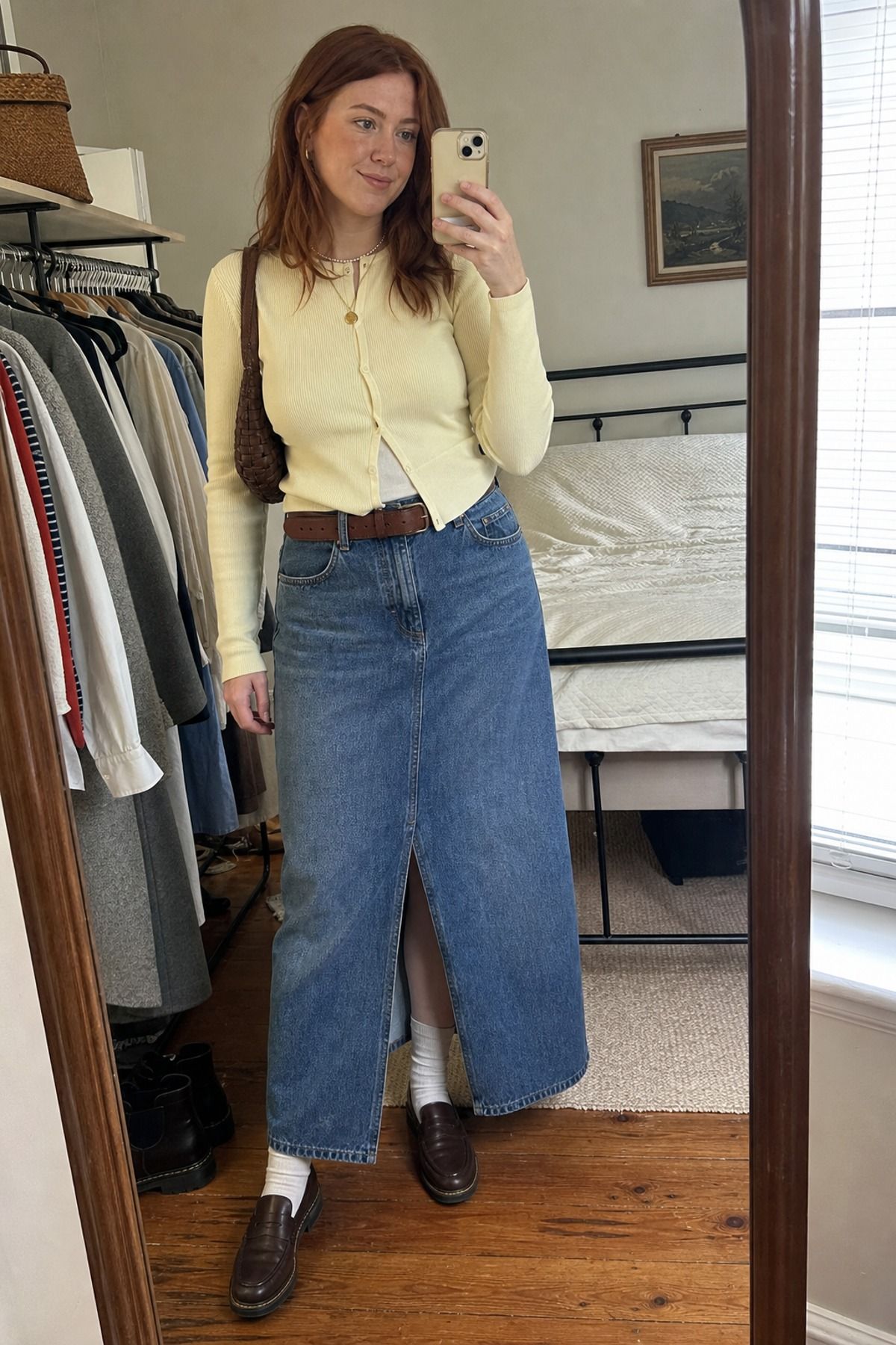 Woman wearing a denim maxi skirt with a cardigan