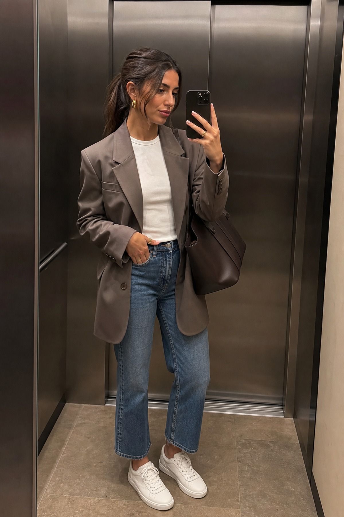 Woman wearing jeans with a blazer and sneakers, a jeans and blazer outfit