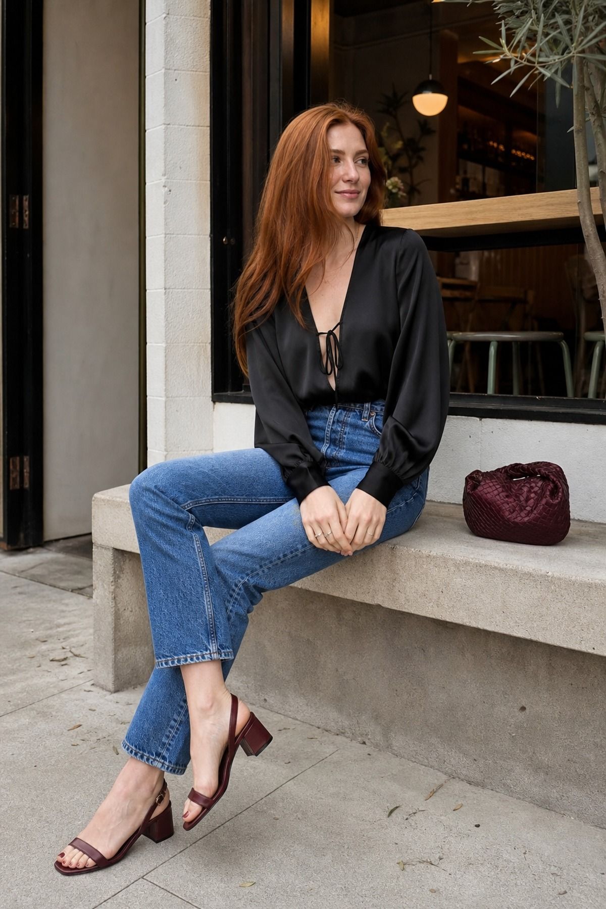 Woman wearing jeans with a black nice top, a jeans and nice top outfit