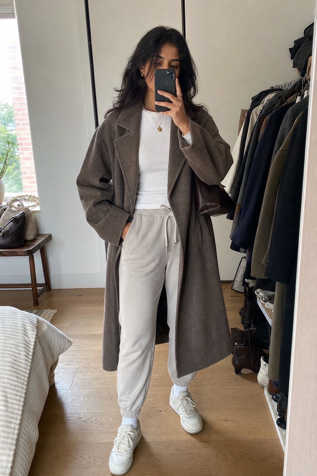 Woman wearing joggers with a wool coat