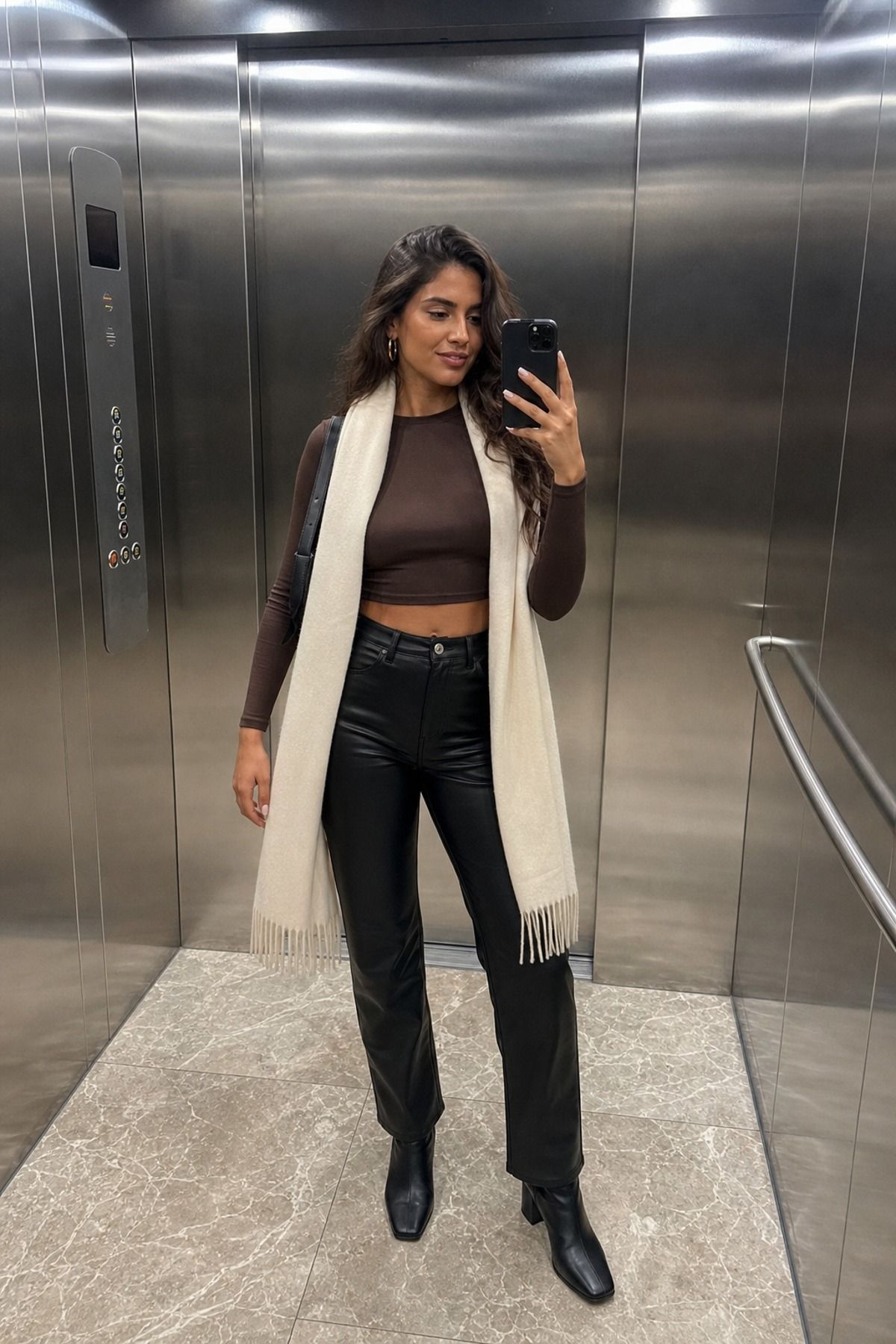 Woman wearing leather pants with crop top