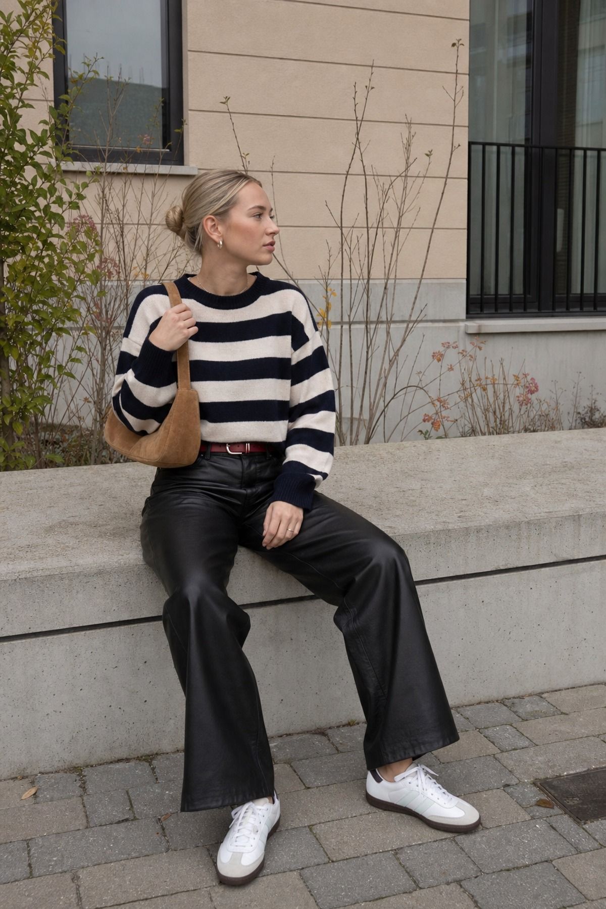 Woman wearing leather pants with striped sweater