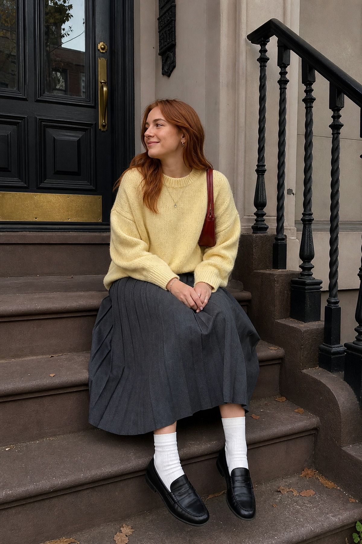 Woman wearing a pleated skirt with a crewneck sweater
