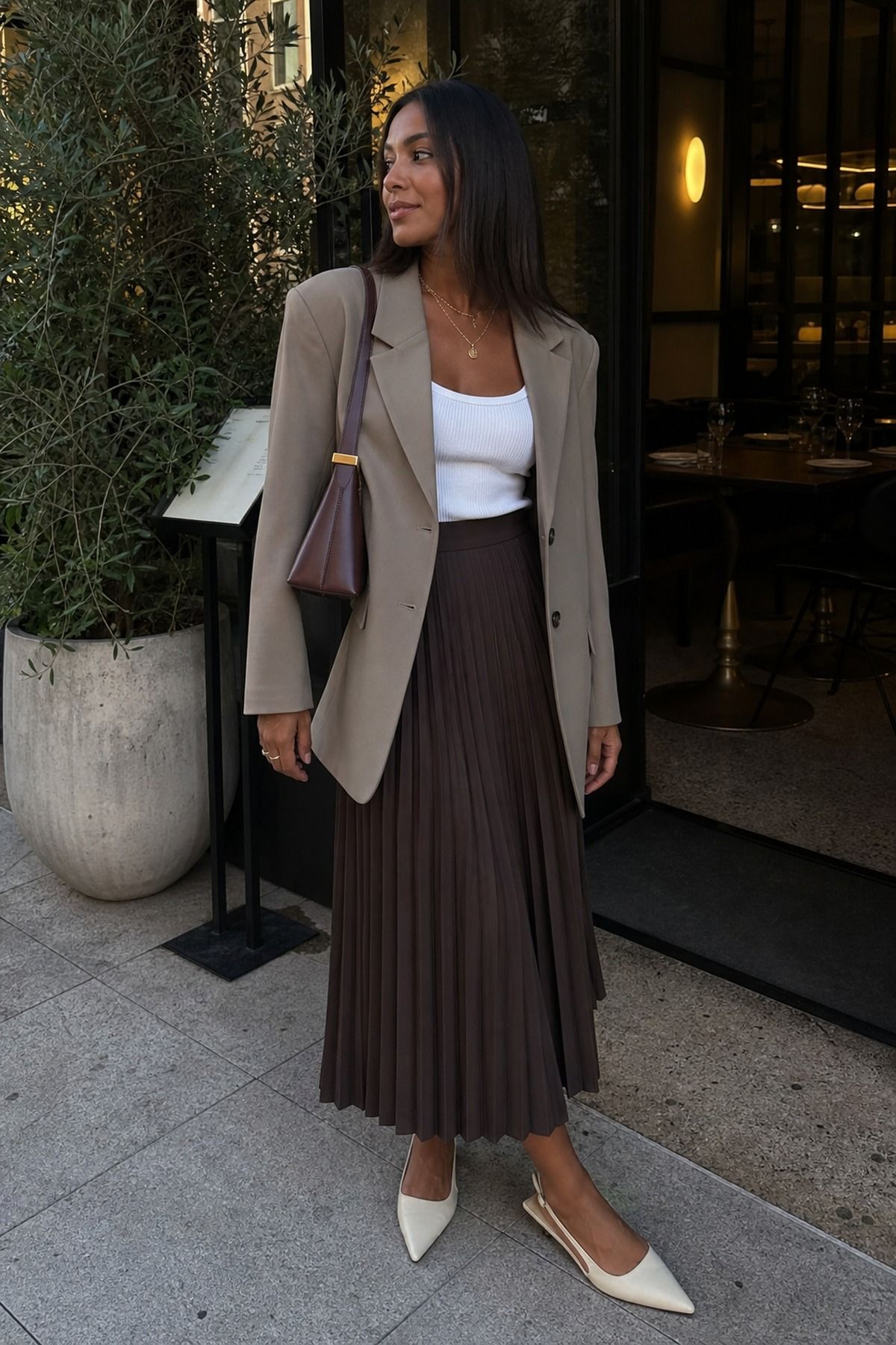 Woman wearing a pleated skirt with a blazer