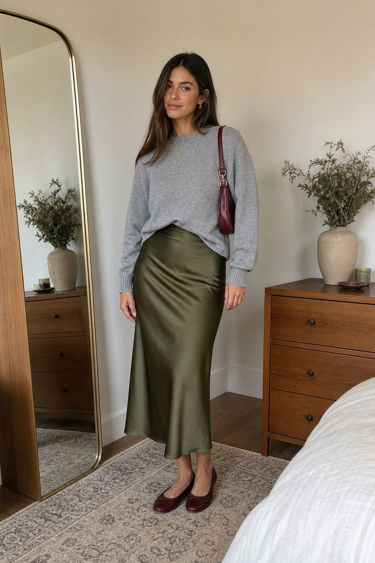 Woman wearing a satin skirt with a crewneck sweater