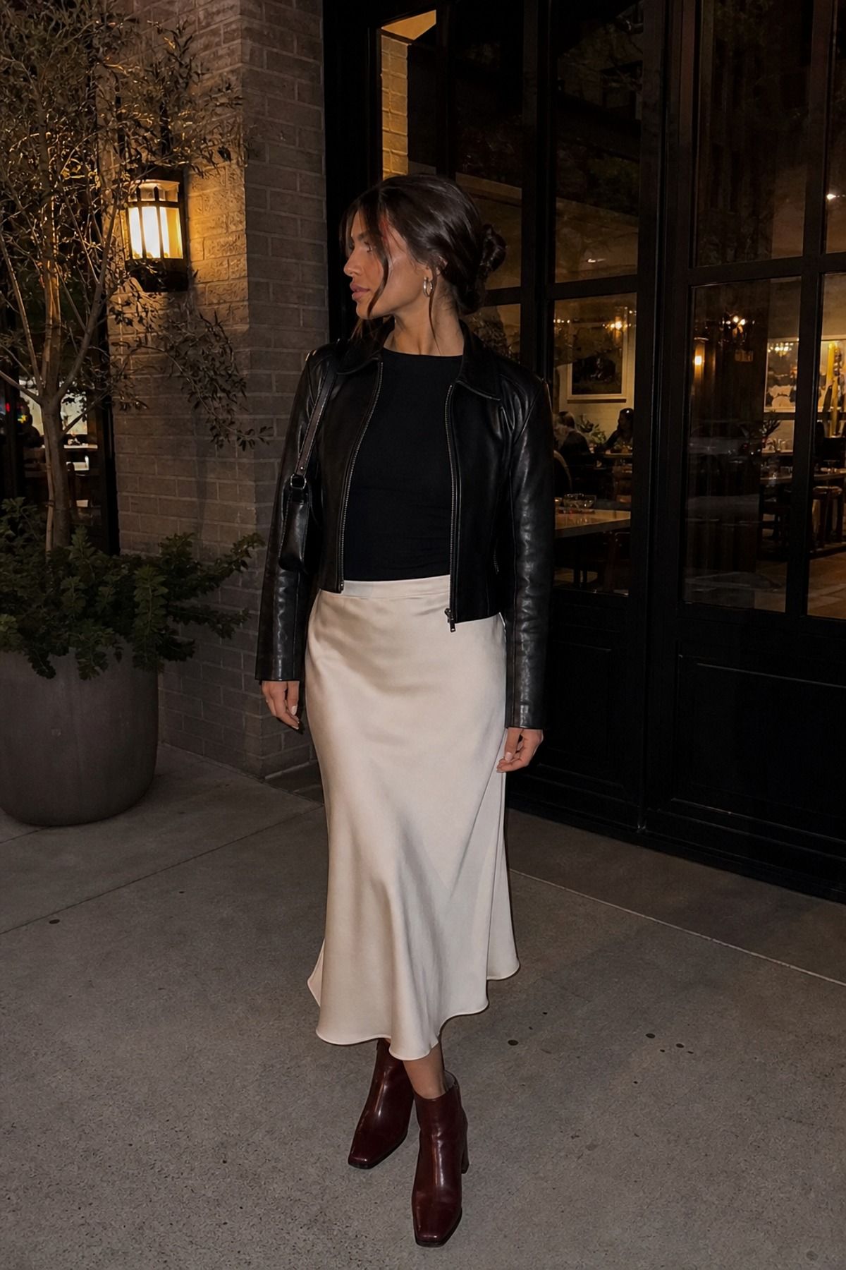 Woman wearing a slip skirt with a leather jacket