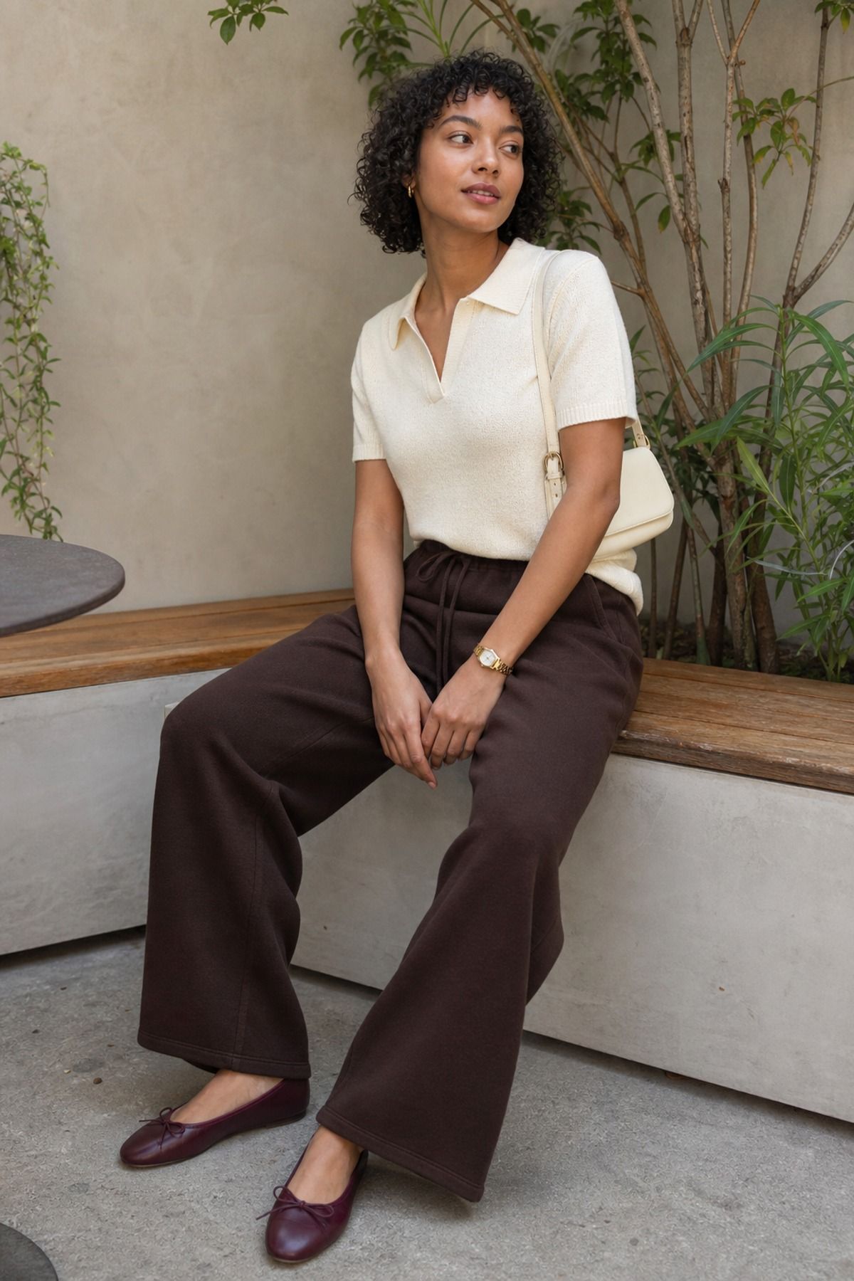 Woman wearing sweatpants with a knit polo