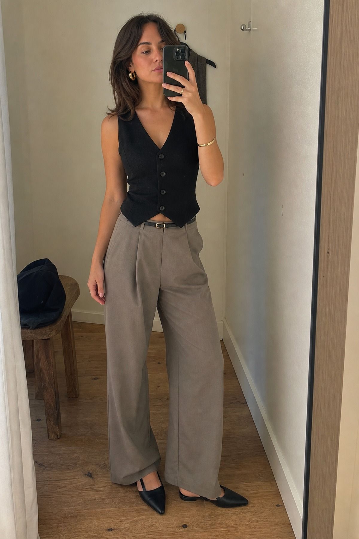 Woman wearing wide leg pants with a vest