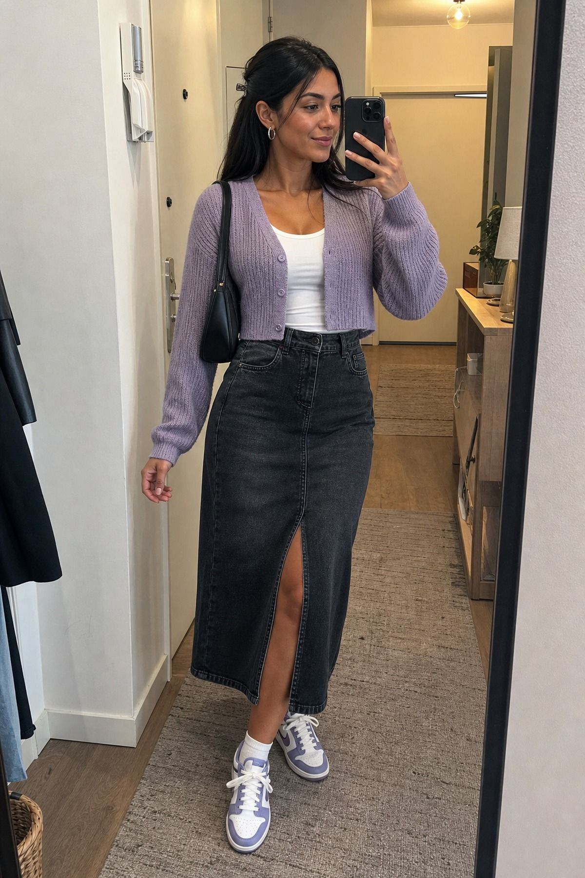 Woman wearing a skirt with a cardigan, a skirt and sneakers outfit