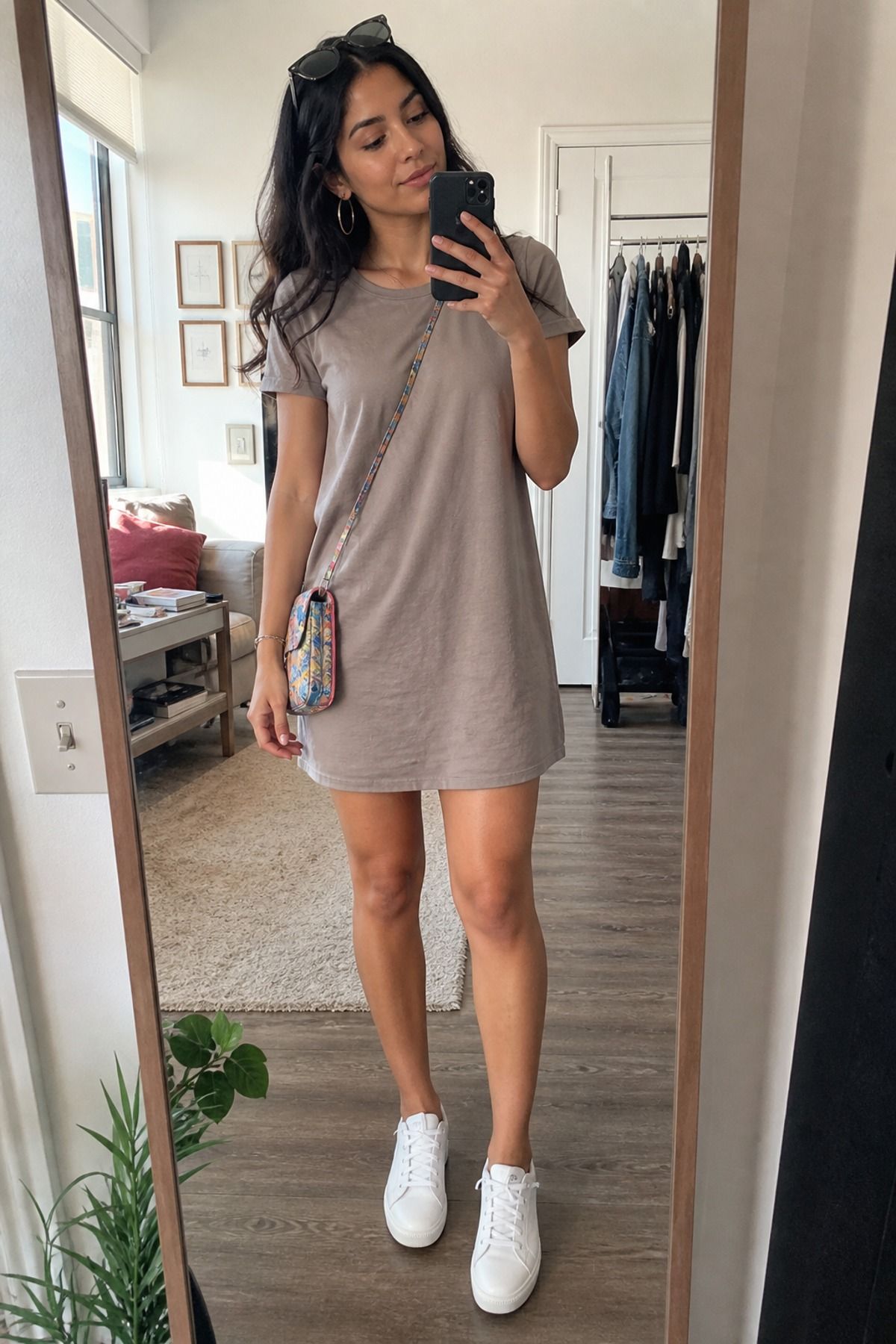 Woman wearing a t-shirt dress with white sneakers