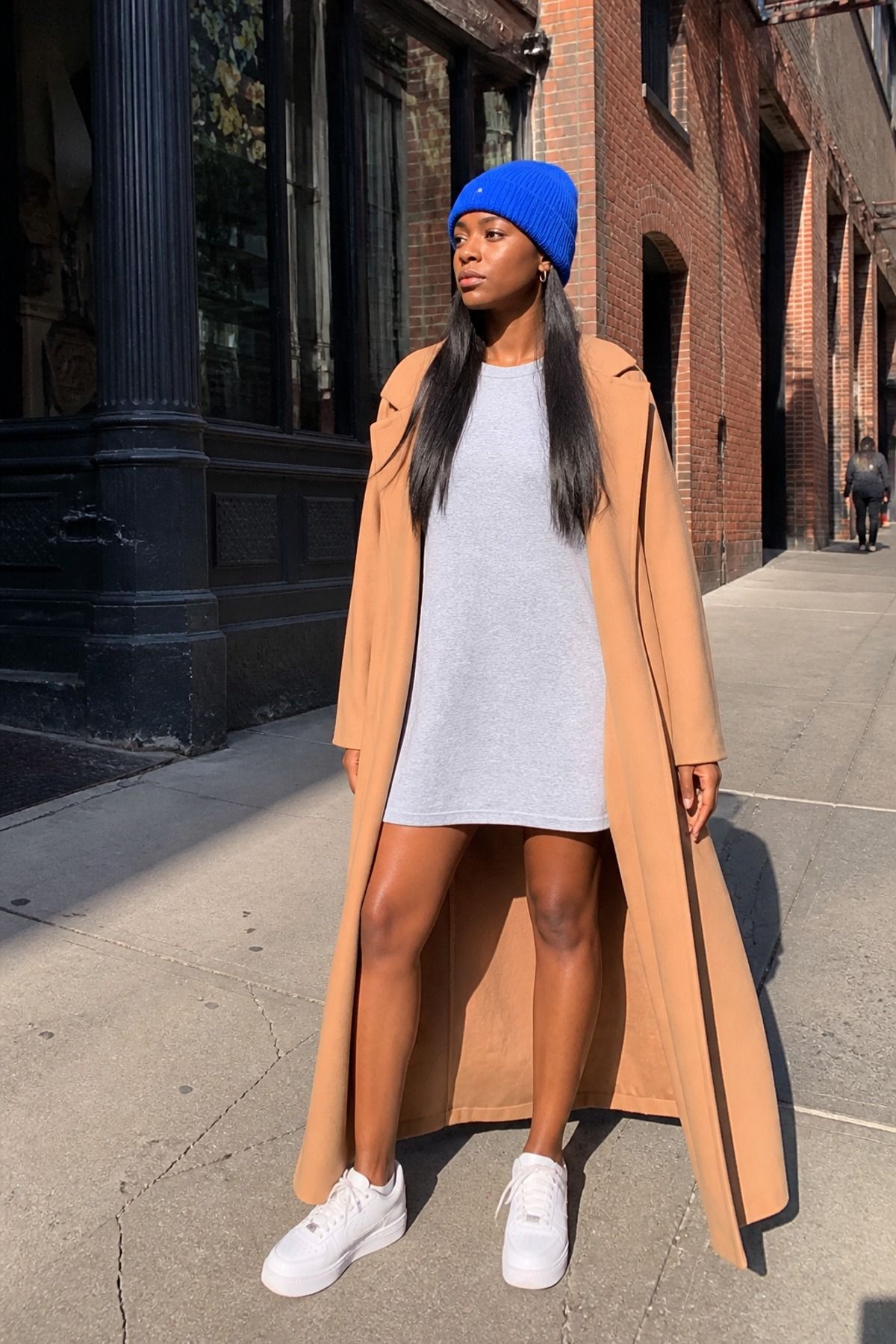 Woman wearing a t-shirt dress with a long coat