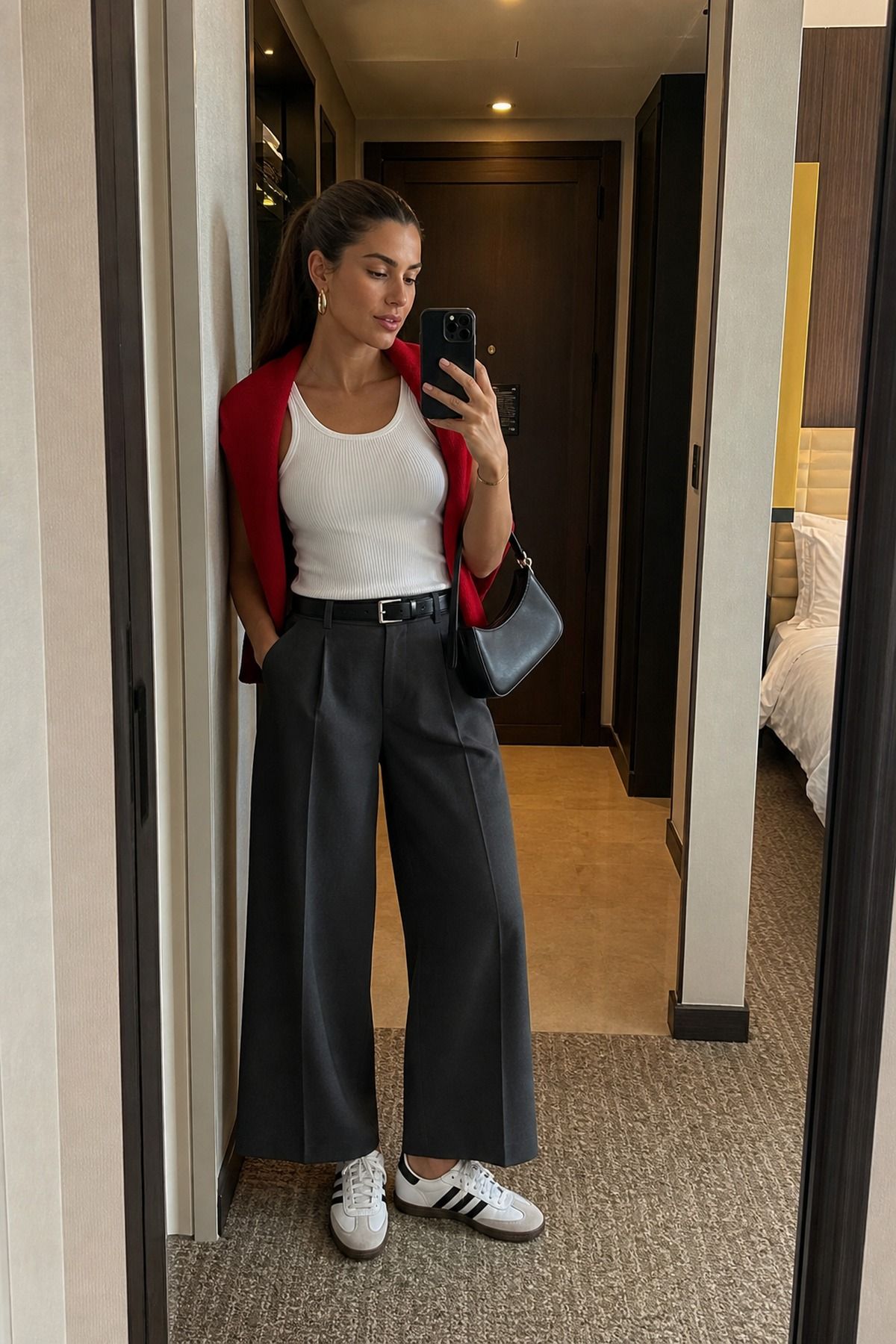 Woman wearing wide-leg trousers with Adidas Sambas