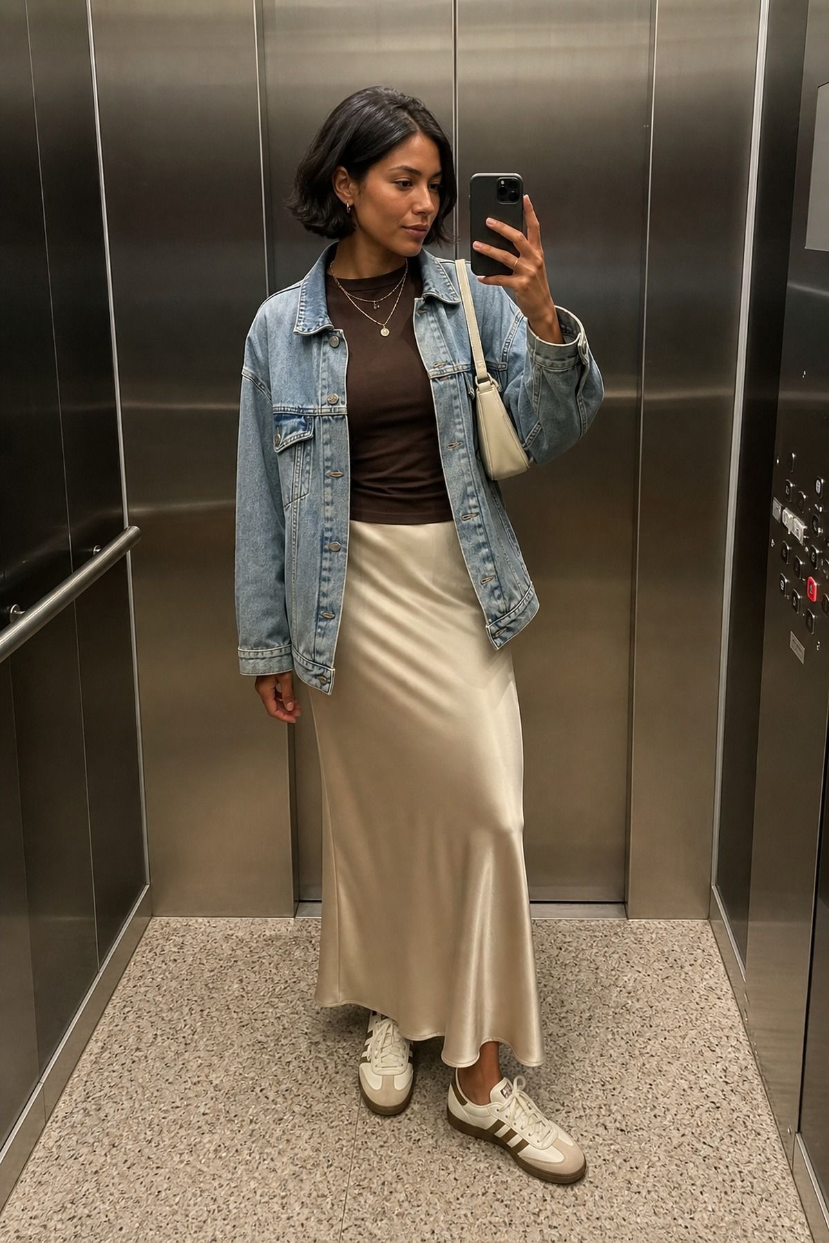 Woman wearing a slip skirt with Adidas Sambas