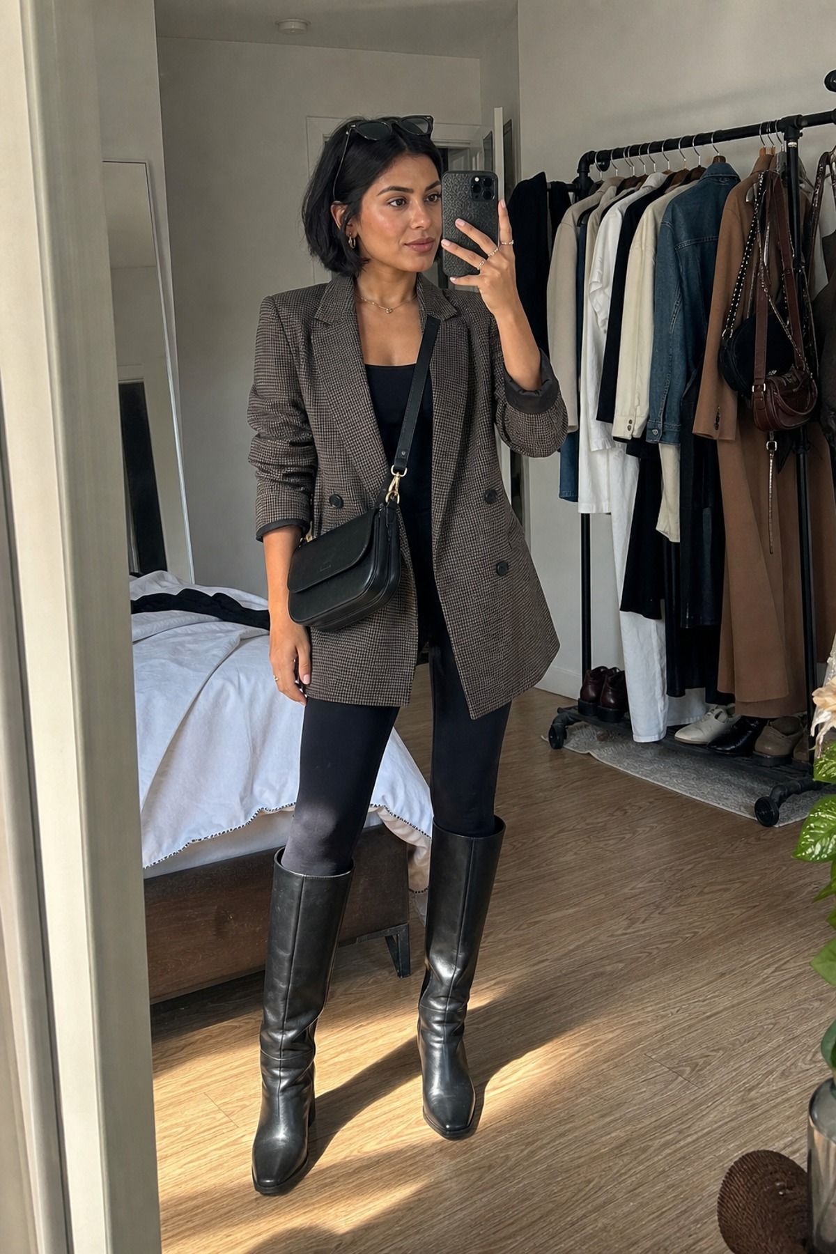 Woman wearing a blazer with leggings and tall boots