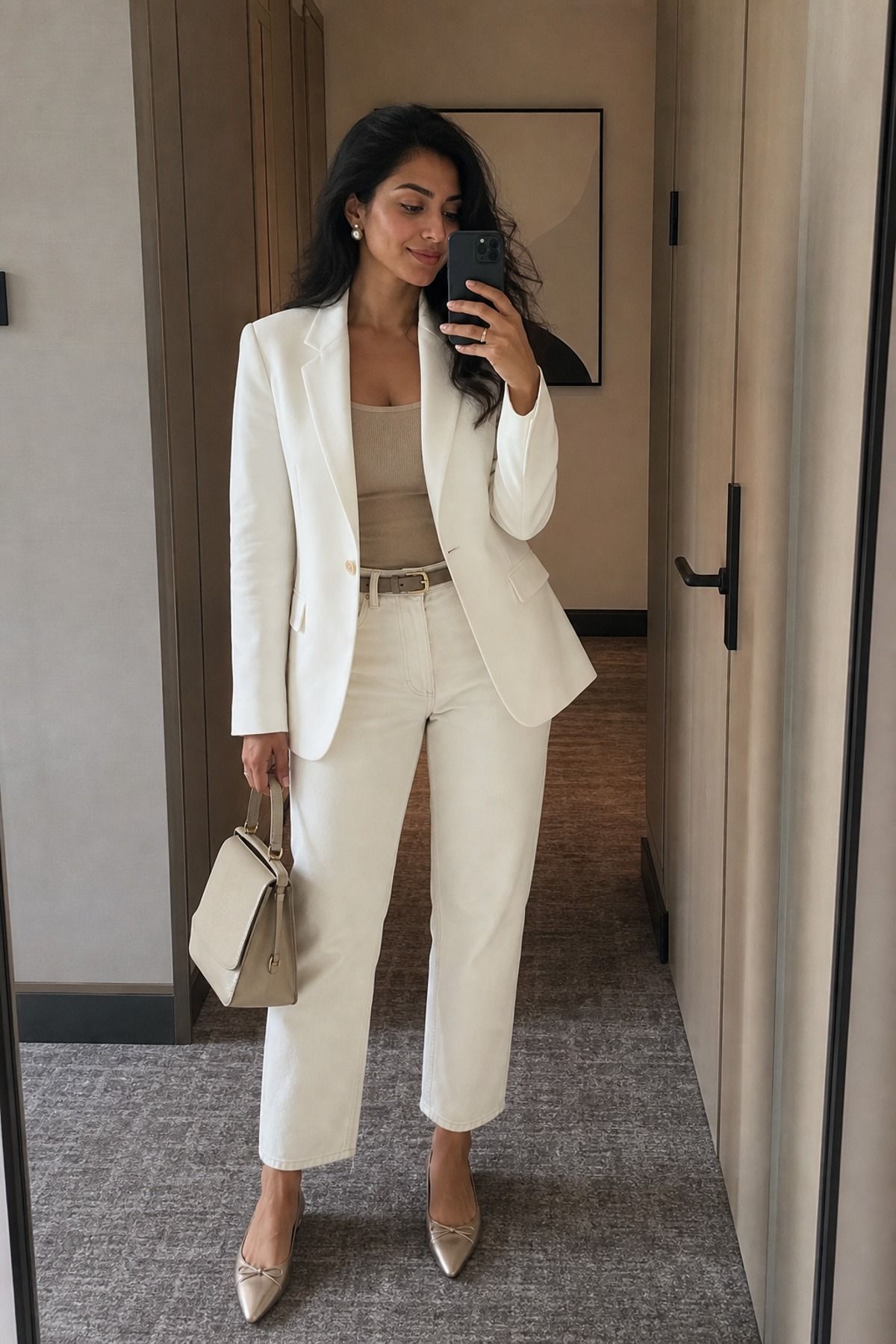 Woman wearing a white blazer with ecru jeans